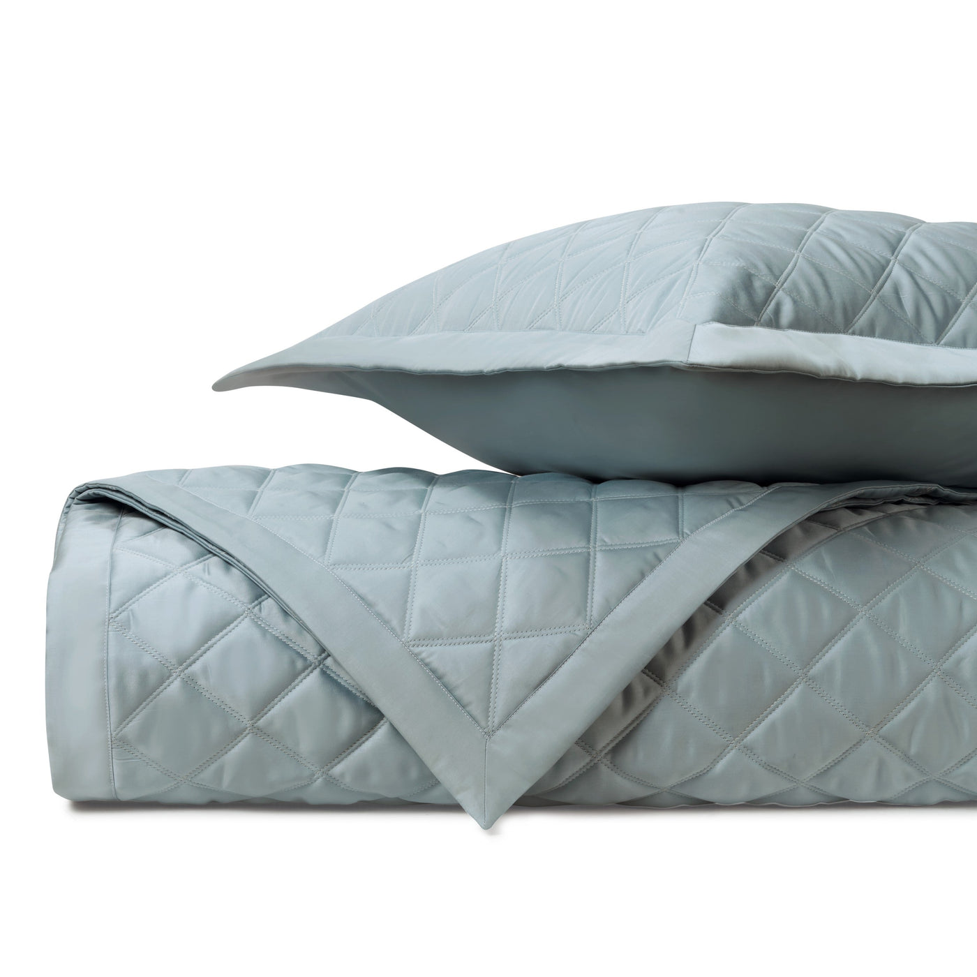 Close-up of Home Treasures Mesa quilted satin in mist blue with diamond stitching.