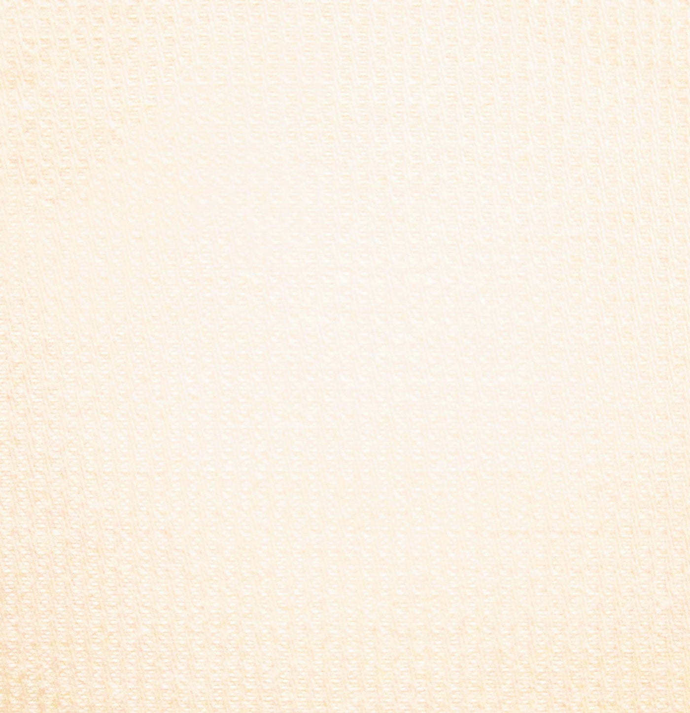 Close-up of ivory woven cotton fabric with subtle textured grid pattern.