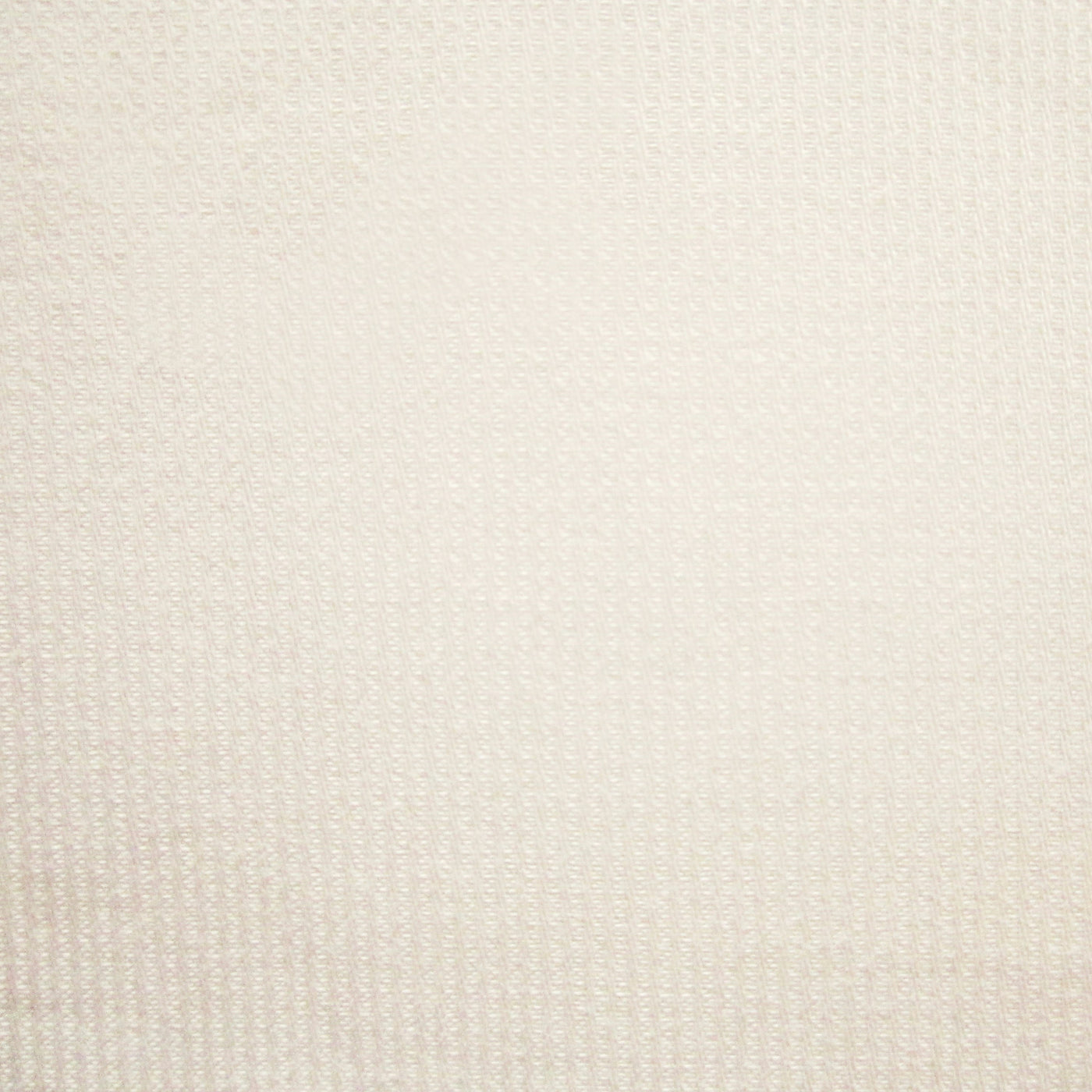 Close-up of ivory woven fabric with subtle textural diamond pattern.