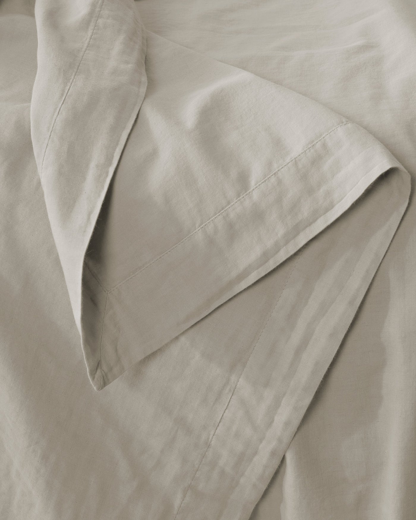 Close-up of Society Limonta Miro pillowcase hem detail in sage linen.