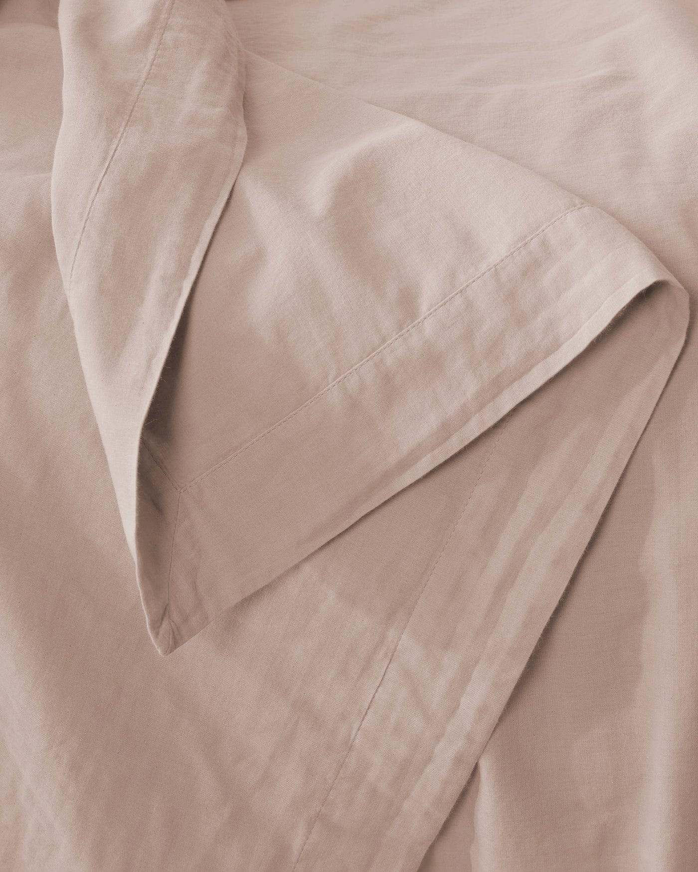 Close-up of Society Limonta Miro pillowcase hem in blush, showing stitched edge detail.