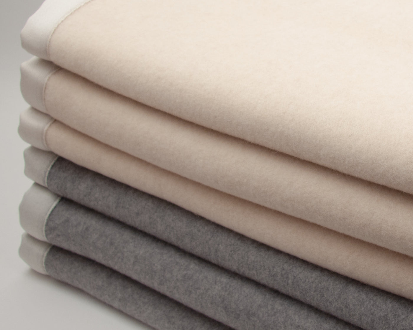 a stack of blankets on a white surface