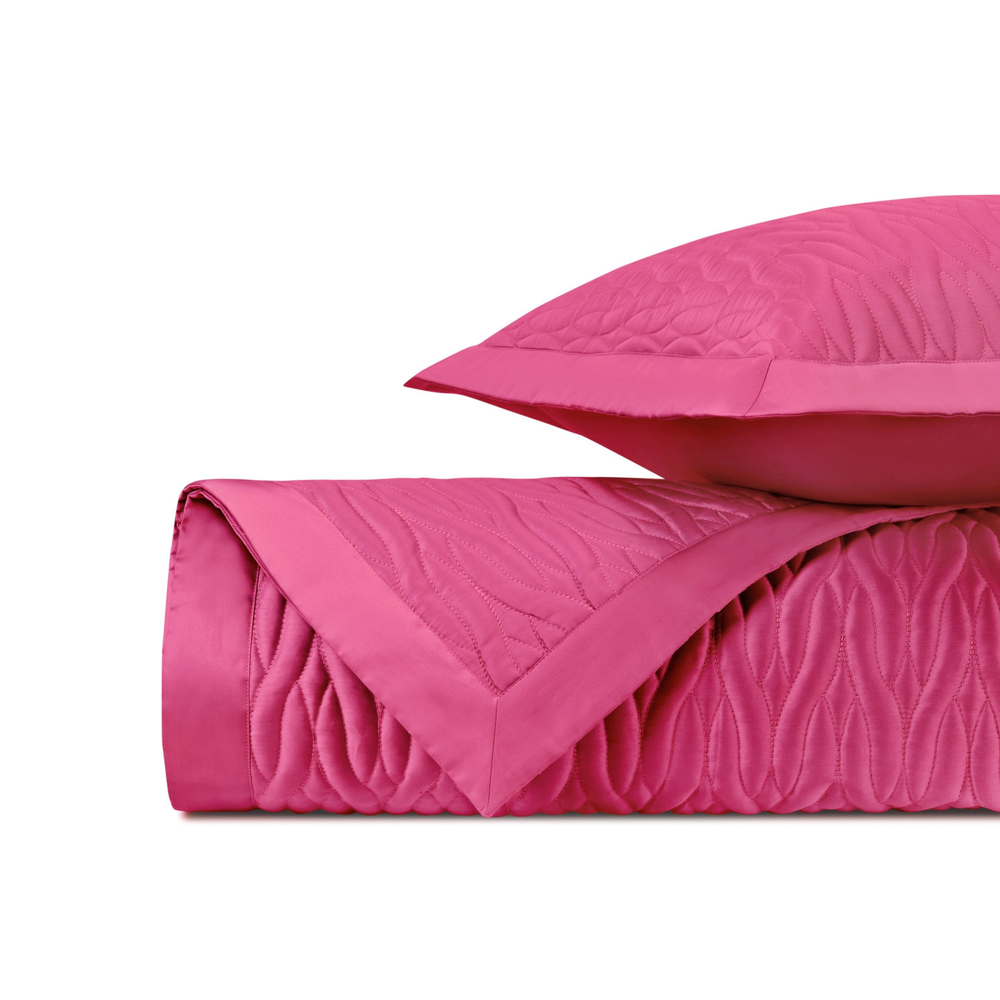 Close-up of fuchsia quilted fabric with flowing wave-stitched texture and satin border.