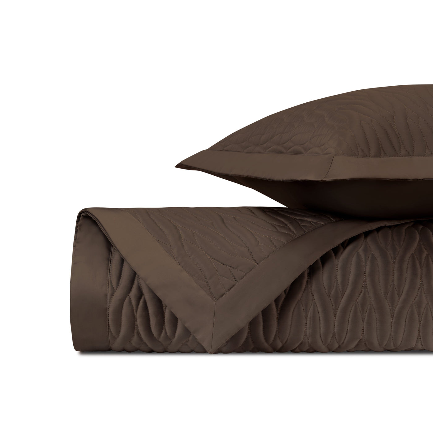 Close-up of Home Treasures Napa quilted coverlet in chocolate with wave stitching.