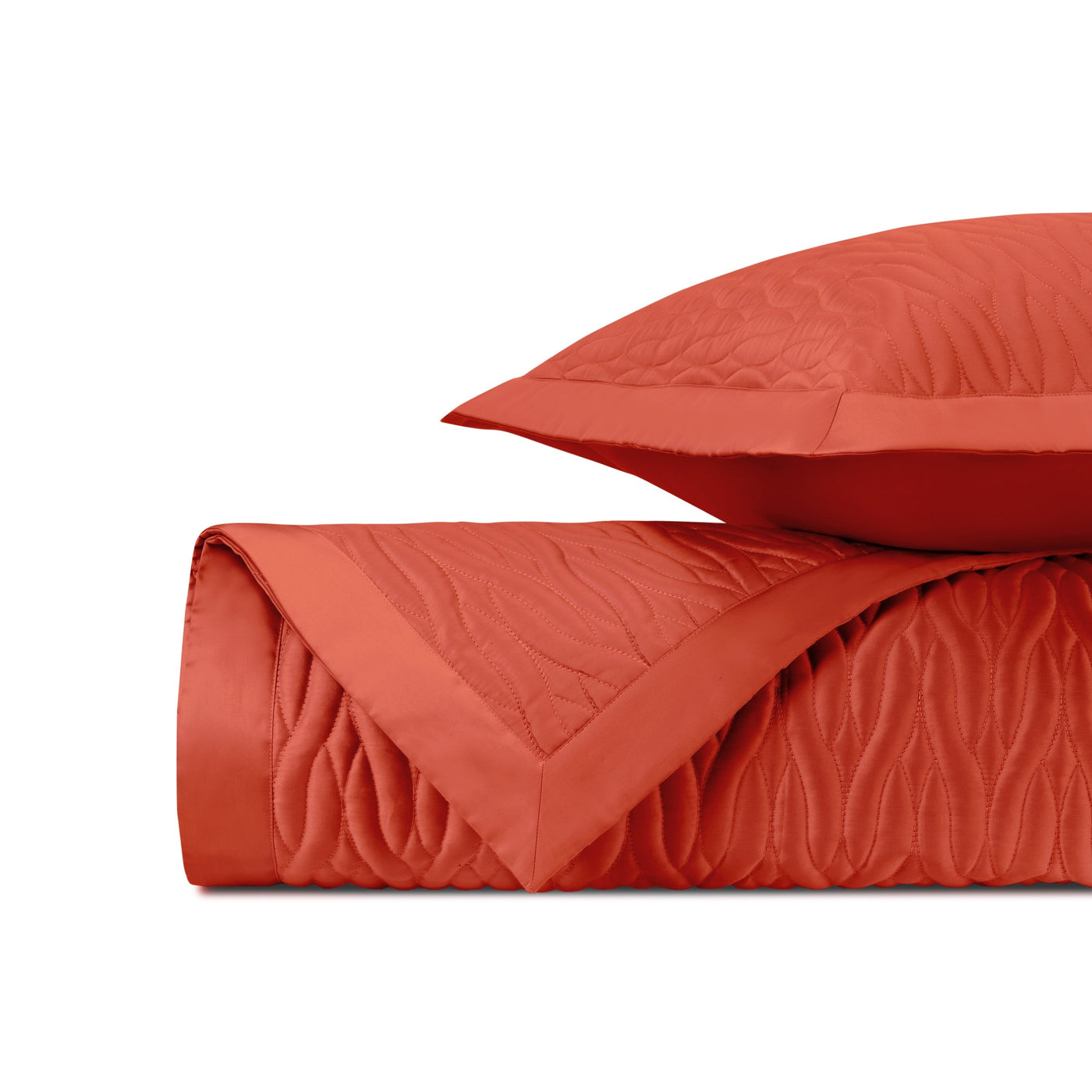 Close-up of tomato red quilted texture with wave pattern stitching detail.