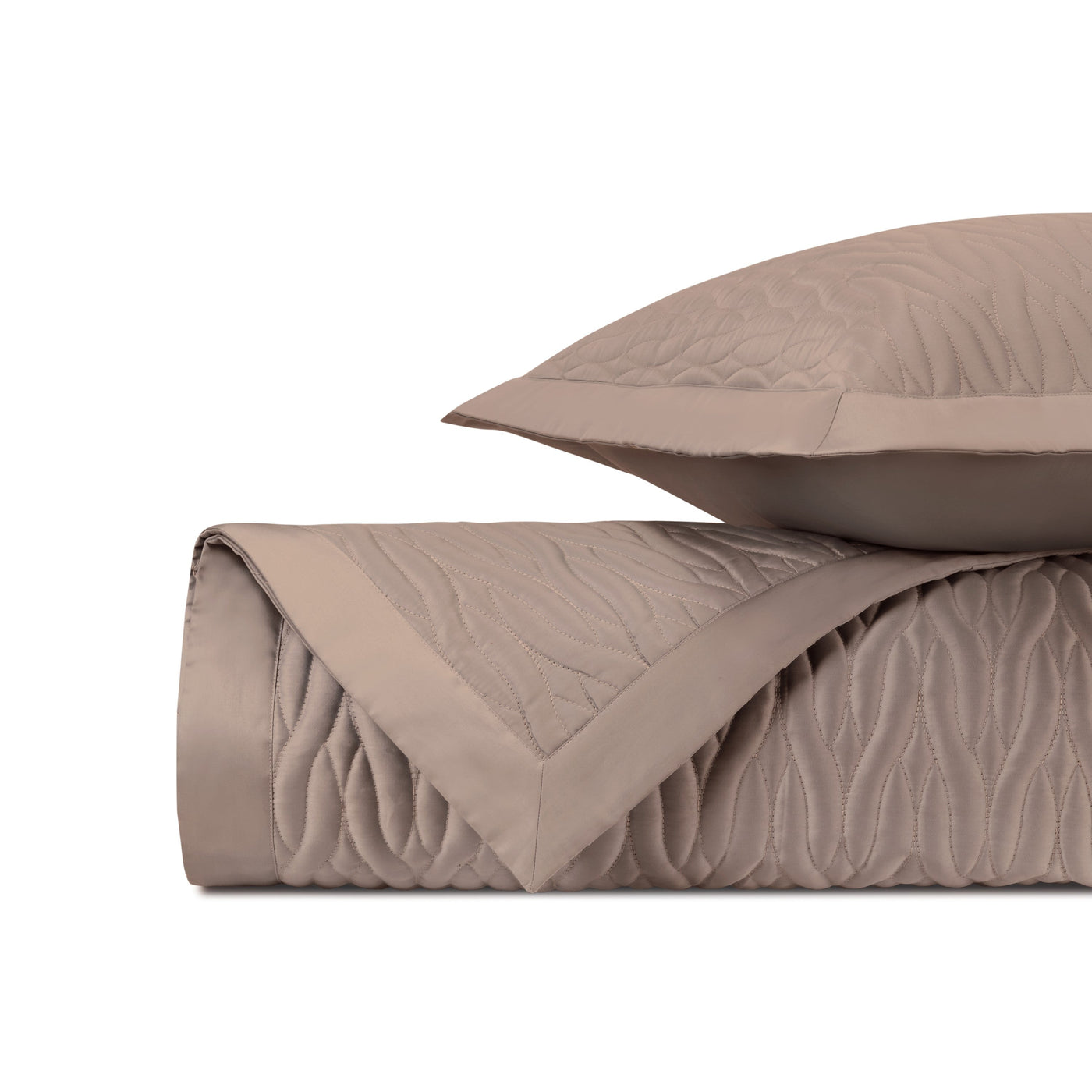Close-up of Napa quilted satin in mink with wave-stitched texture and flat border edge.