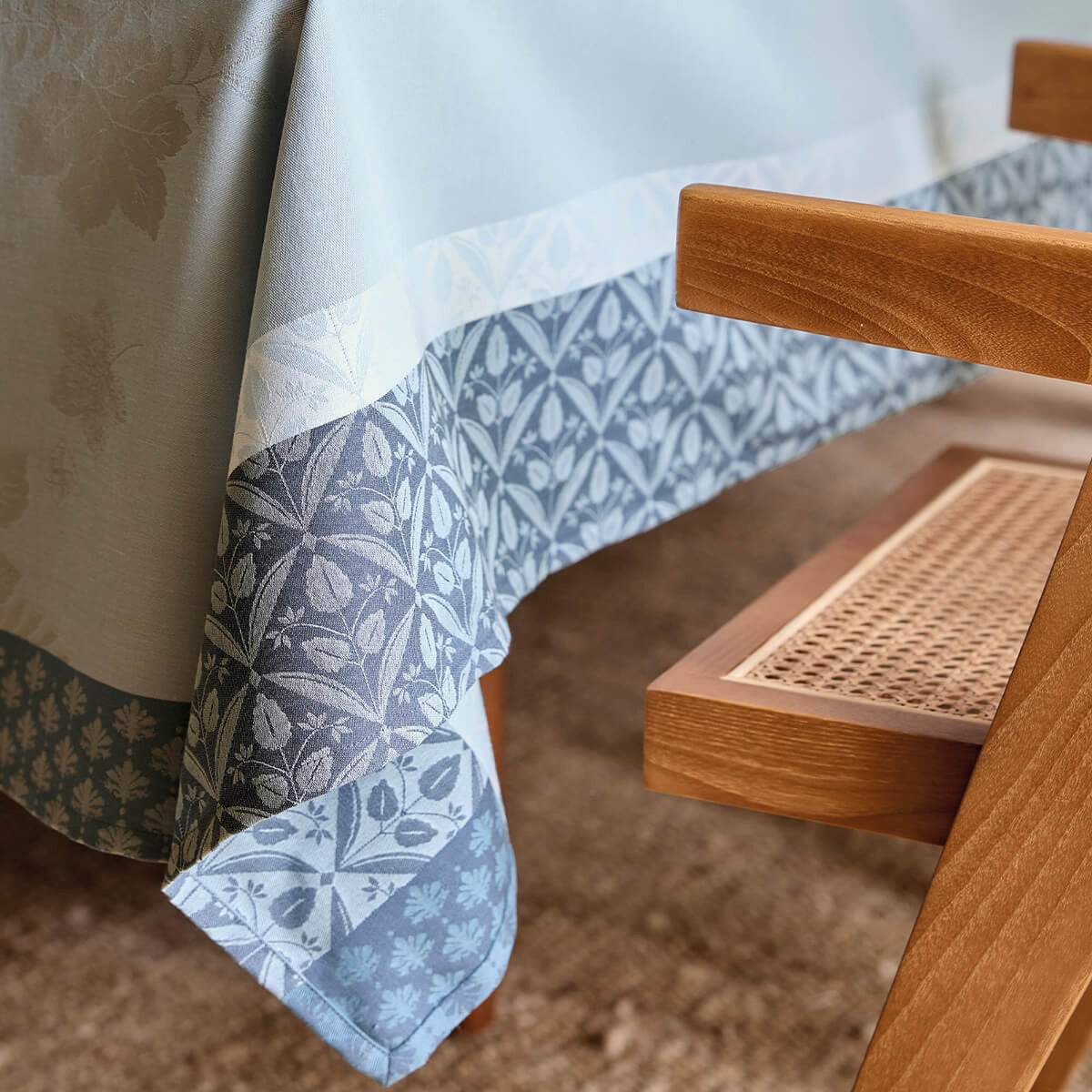 Close-up of Le Jacquard Français Manor Lane tablecloth in Blue, showing floral jacquard border detail.