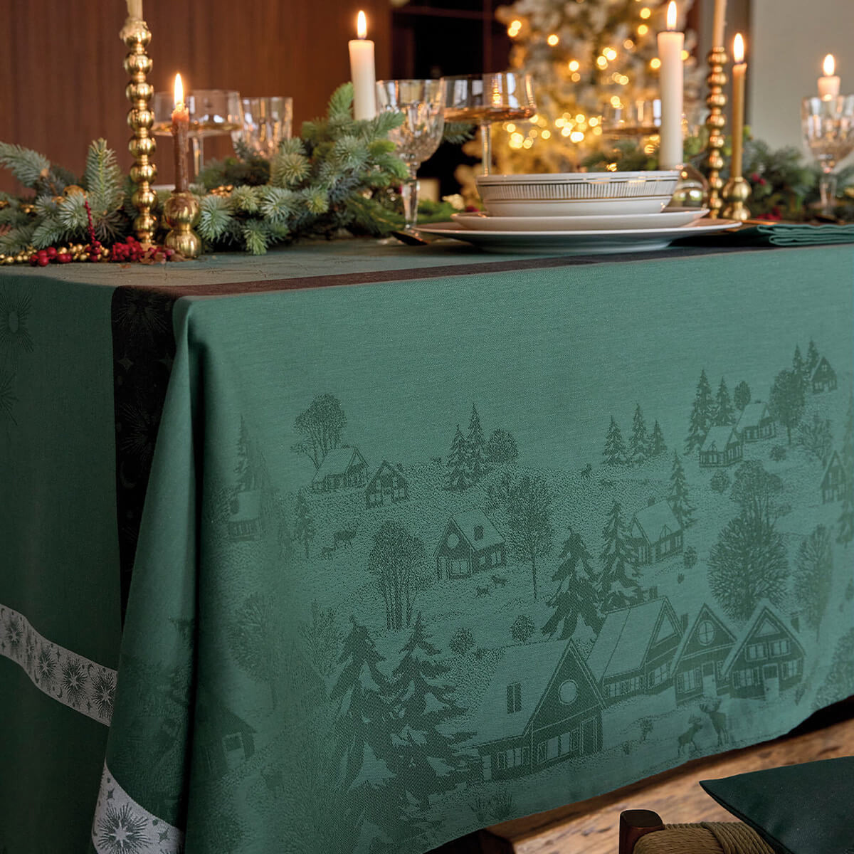 Le Jacquard Français Sous les Étoiles tablecloth in Green, woven winter village scene detail.