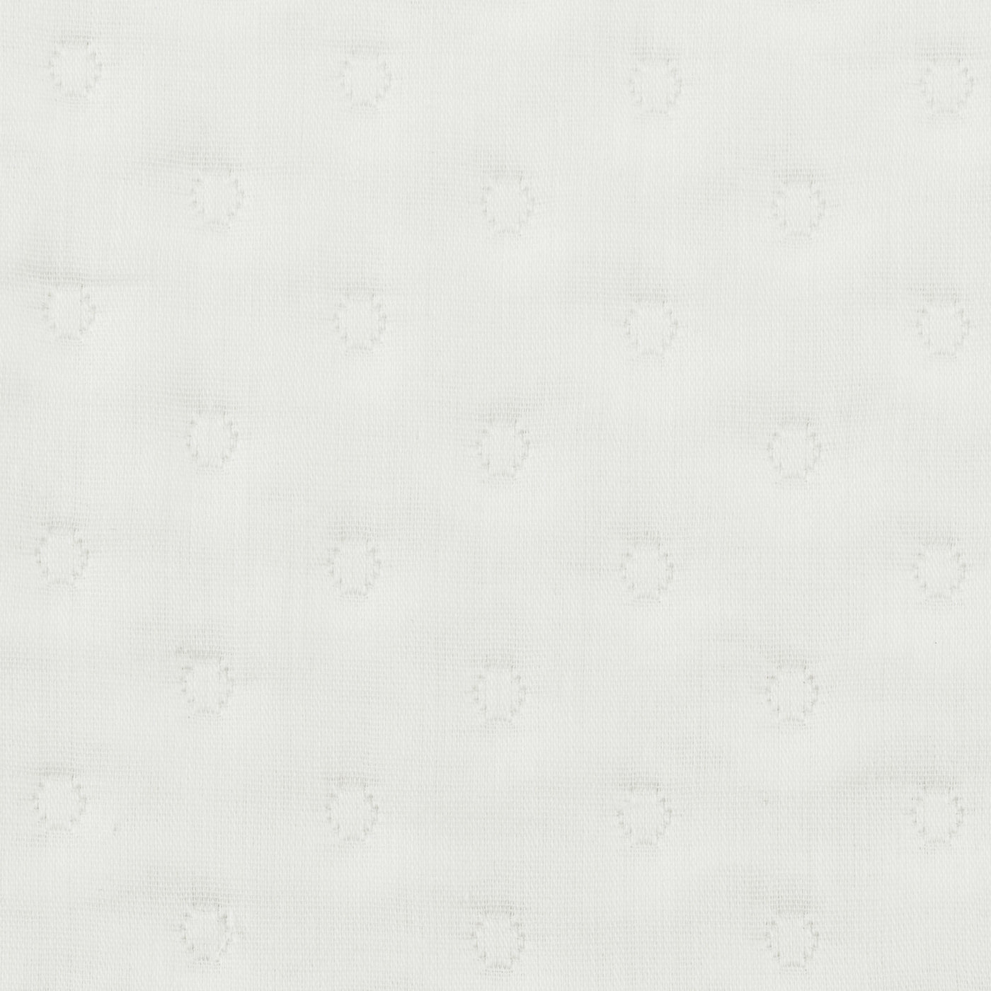 Close-up of ivory cotton fabric with tonal woven dot pattern.
