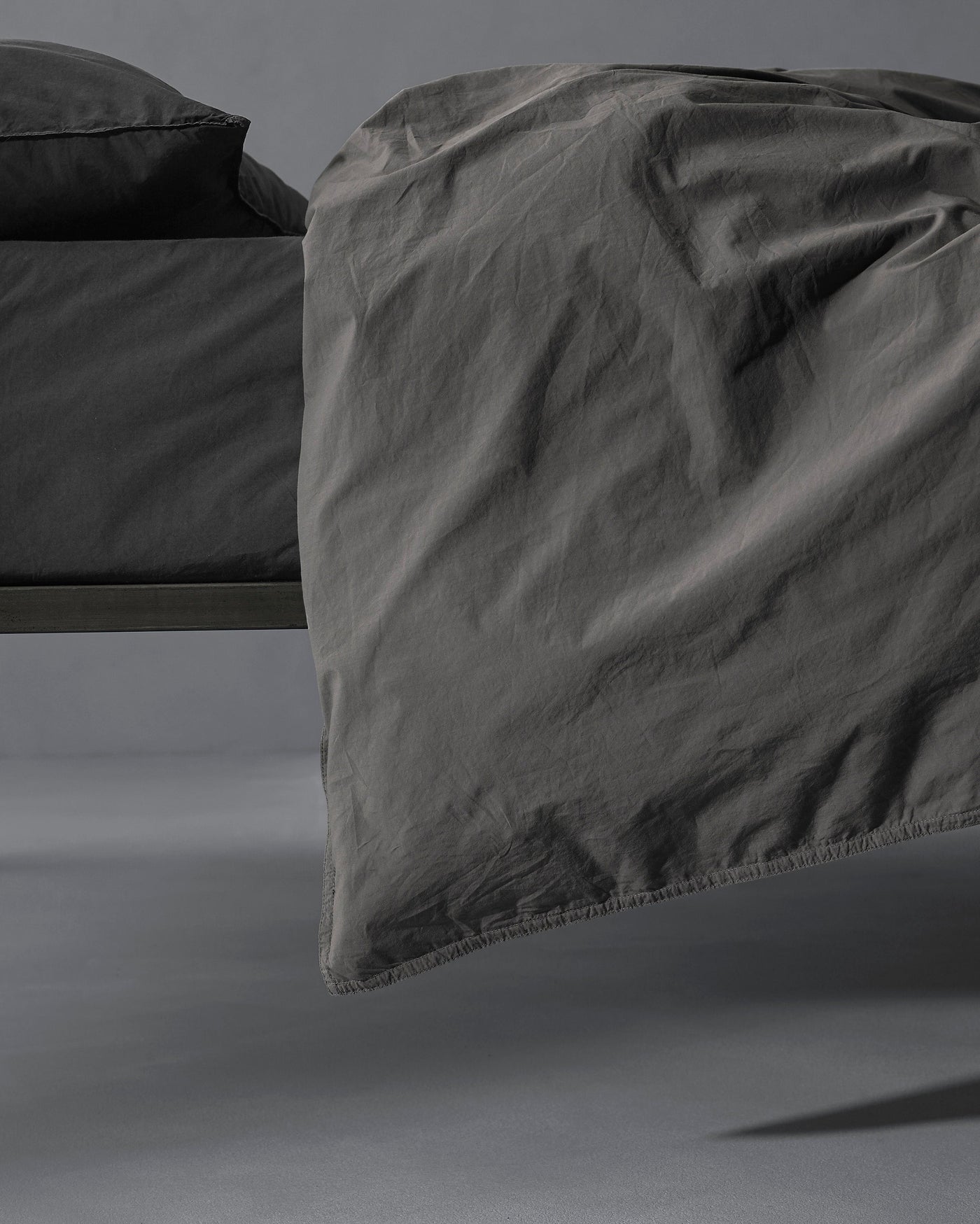 Close-up of Society Limonta Nite duvet cover edge in graphite, showing relaxed linen drape.