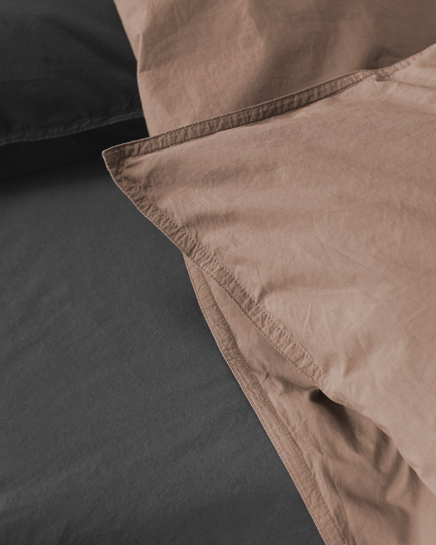 Close-up of Society Limonta Nite duvet cover corner in mocha and charcoal cotton.