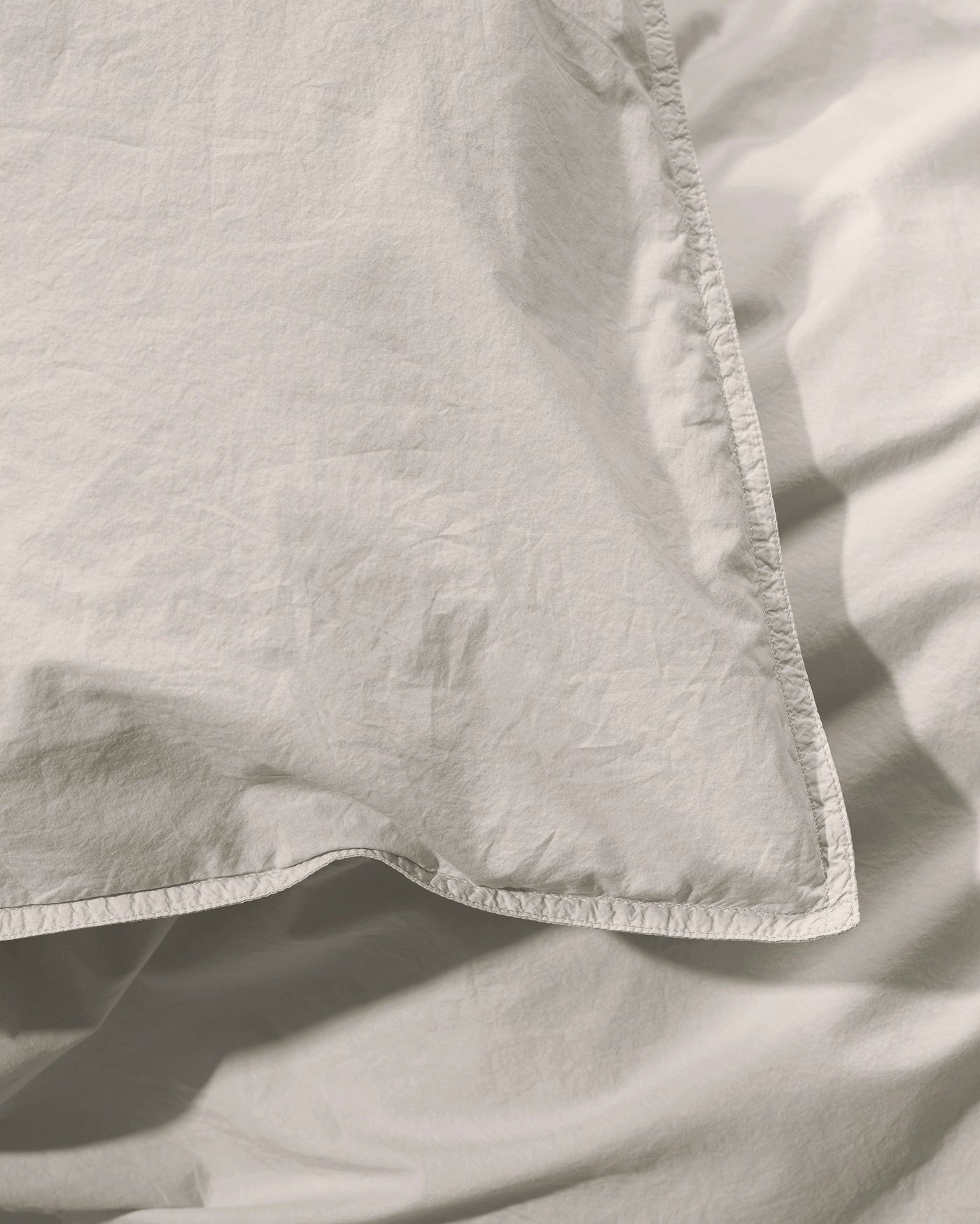 Close-up of Nite duvet cover corner seam detail in natural linen.