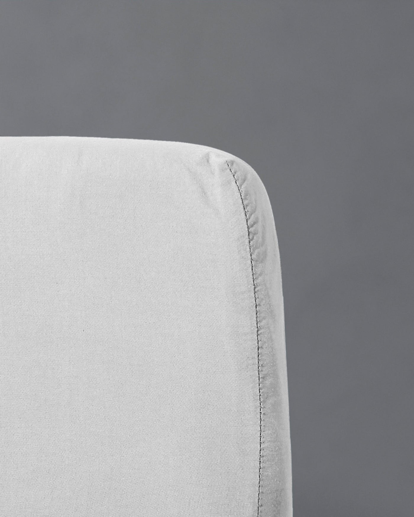 Close-up of Society Limonta Nite fitted sheet corner seam in pearl linen.