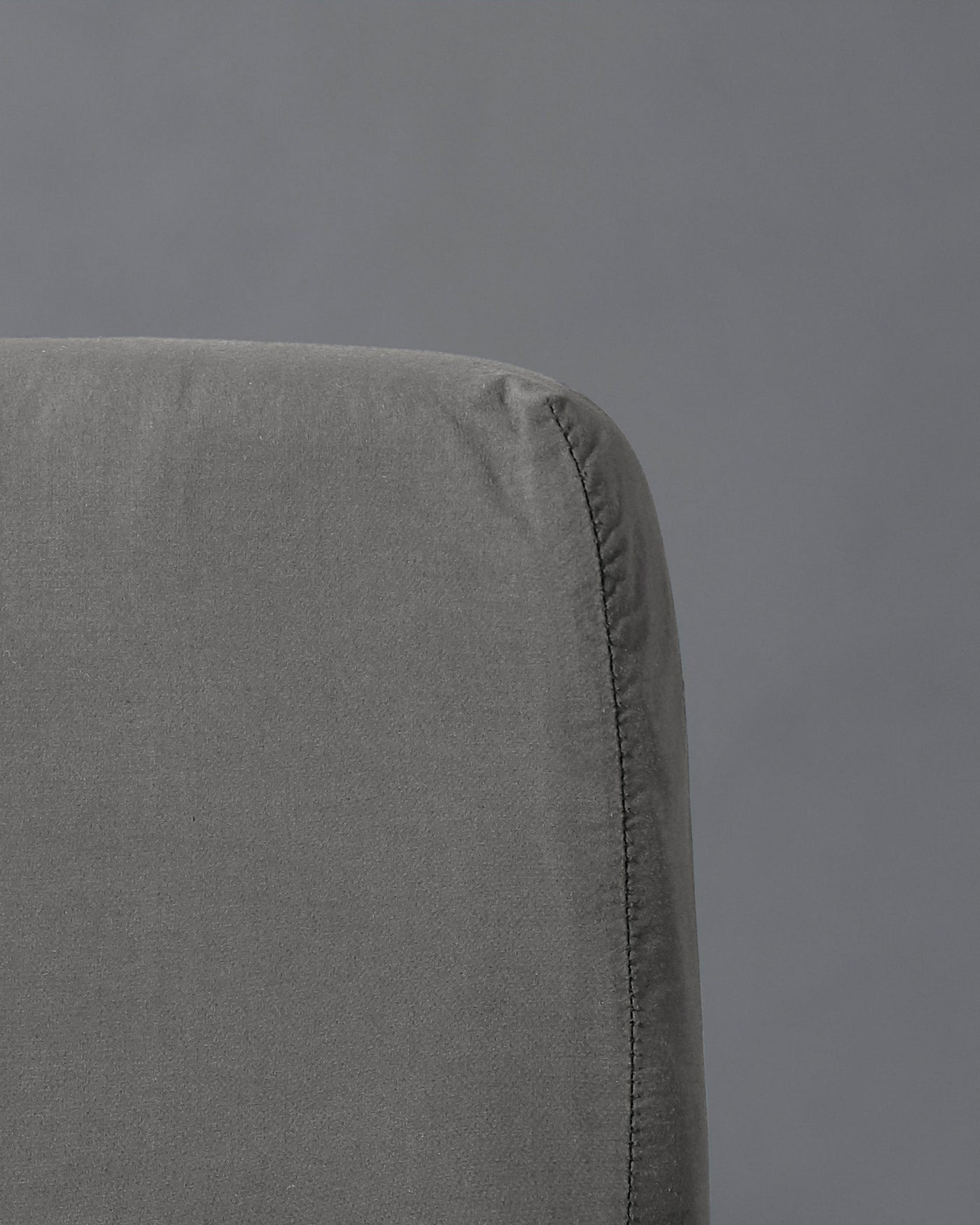 Close-up of Society Limonta Nite fitted sheet corner in slate grey washed cotton.