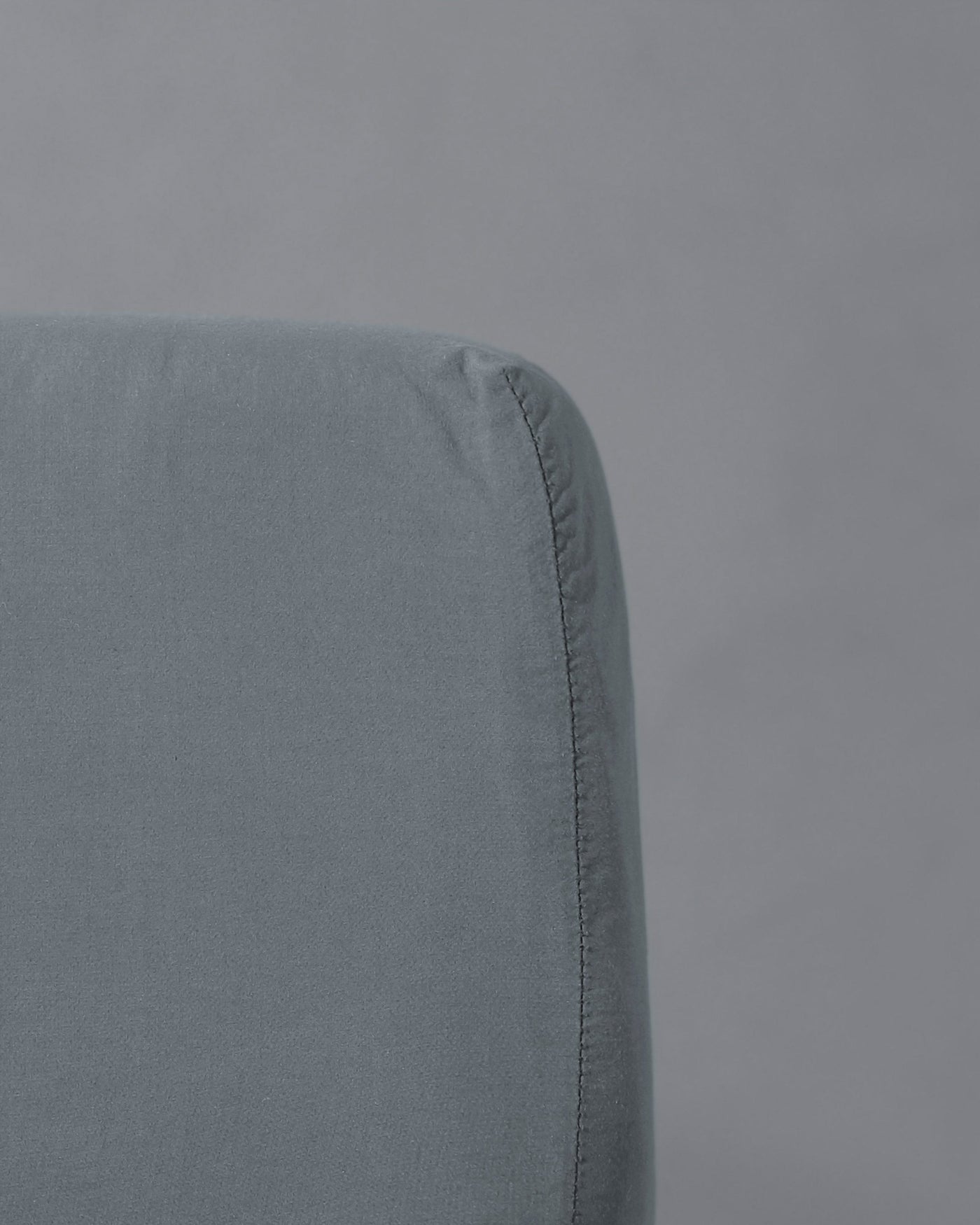 Close-up of Society Limonta Nite fitted sheet corner in slate blue linen.