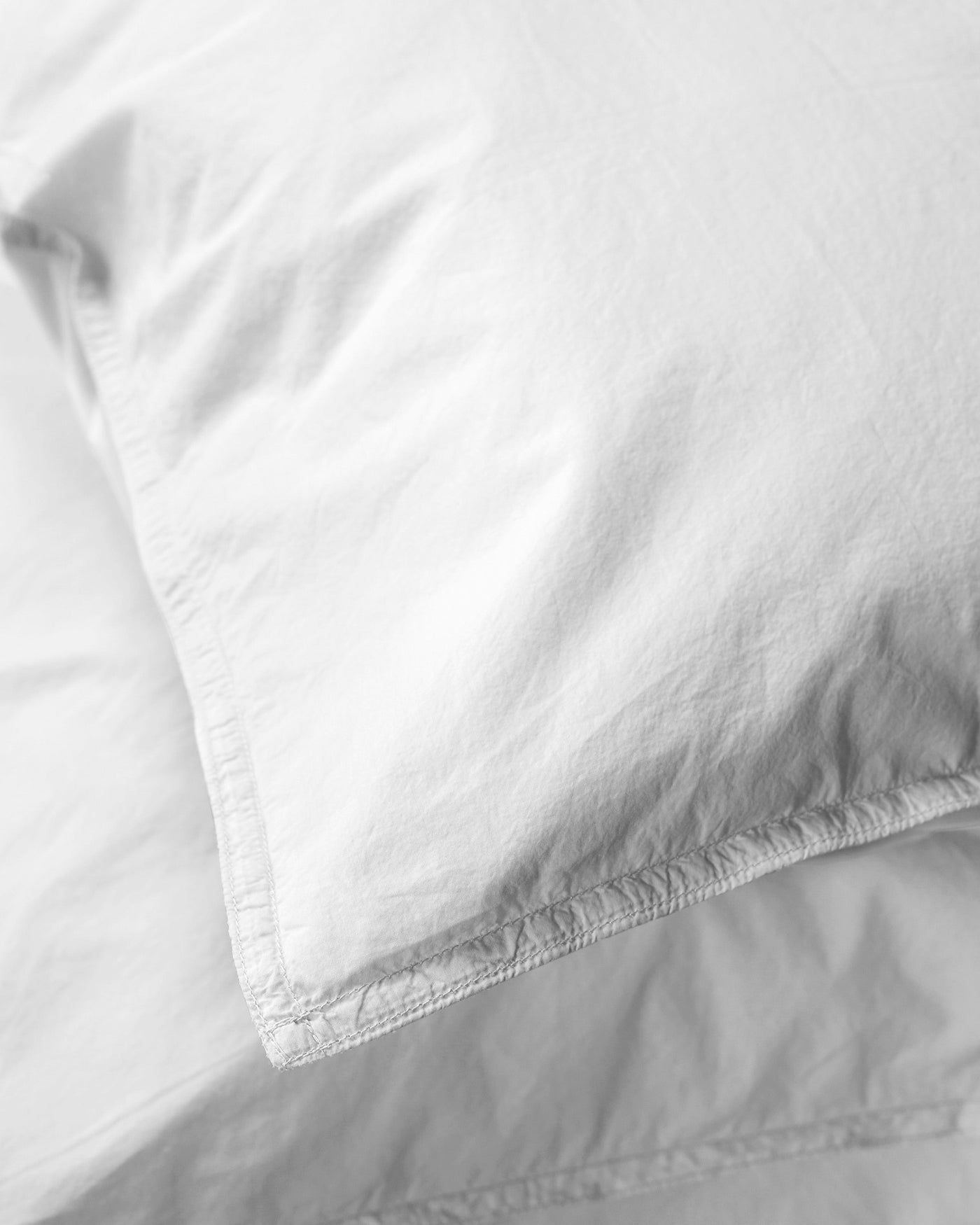 Close-up of Society Limonta Nite pillowcase corner seam in white cotton.
