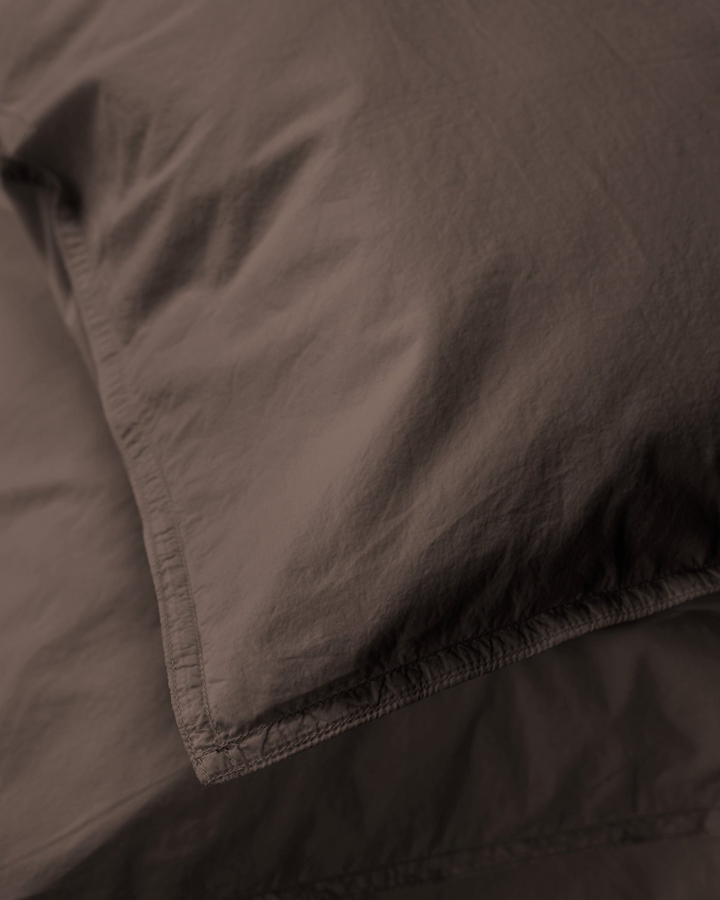 Close-up of Society Limonta Nite pillowcase corner seam in deep espresso cotton.