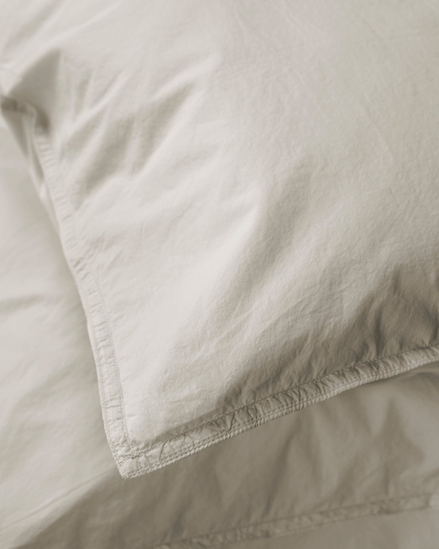 Close-up of Society Limonta Nite pillowcase corner seam detail in natural linen.