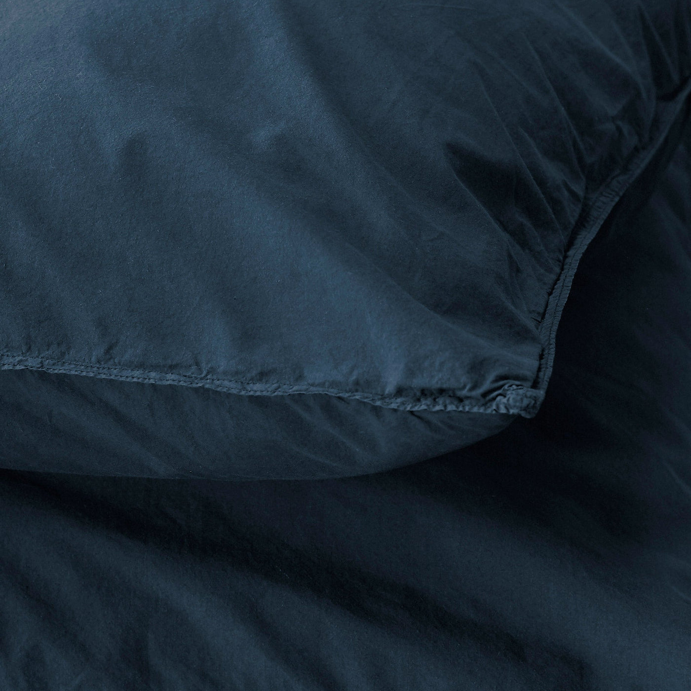 Close-up of Society Limonta Nite pillowcase seam detail in midnight blue linen.
