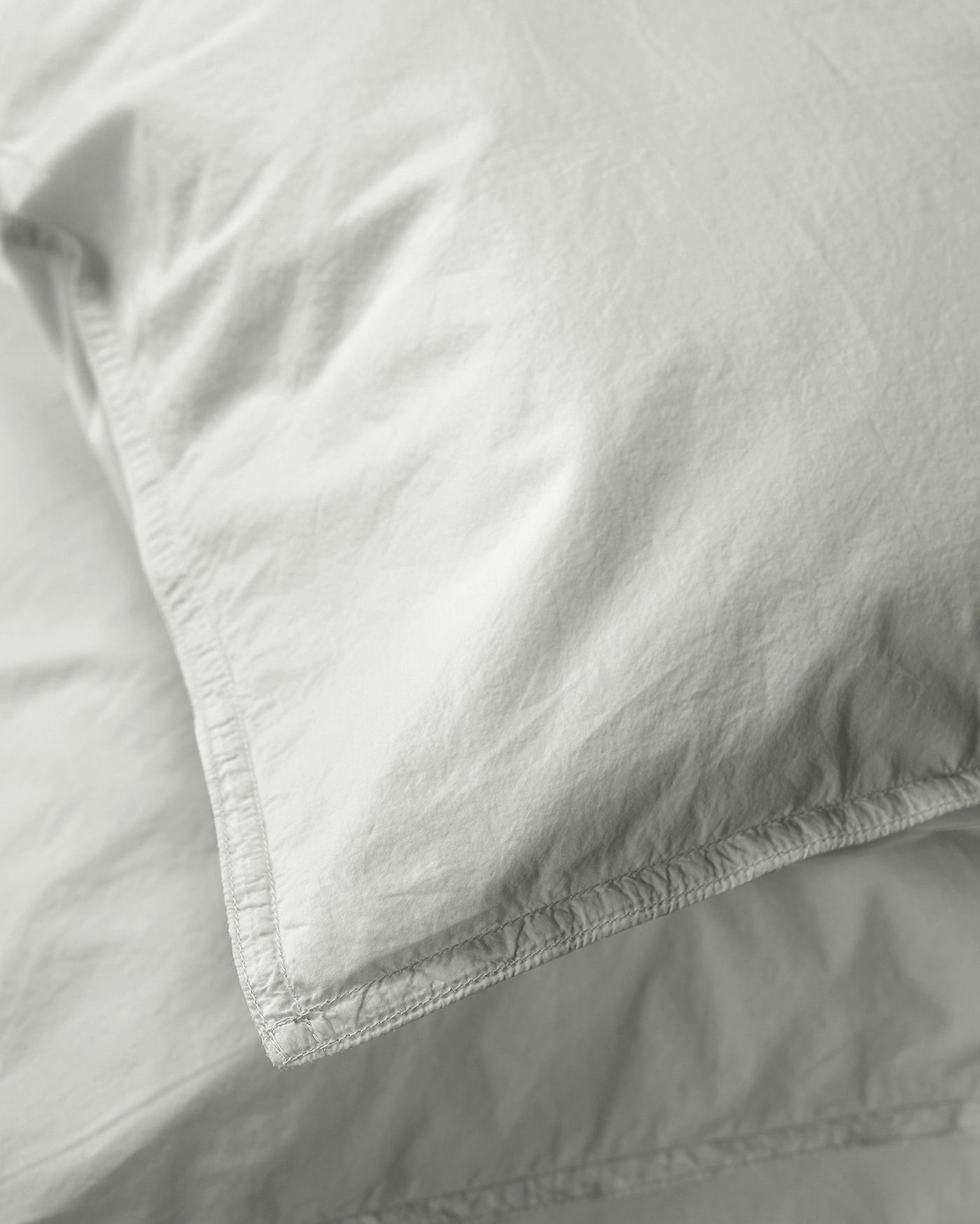 Close-up of Society Limonta Nite pillowcase hem stitching in soft sage linen.