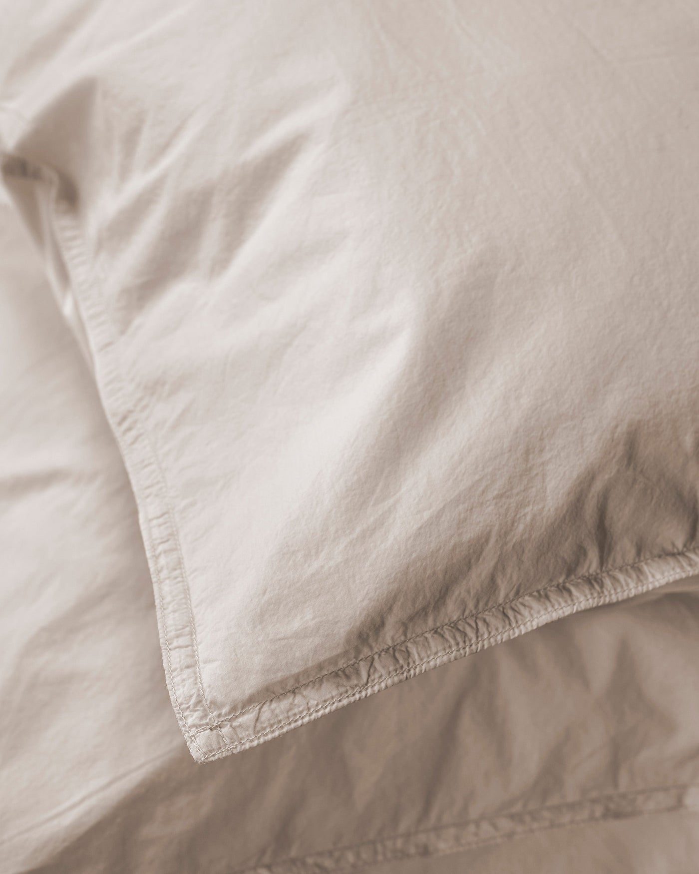 Close-up of Society Limonta Nite pillowcase corner seam in sandy linen-cotton.