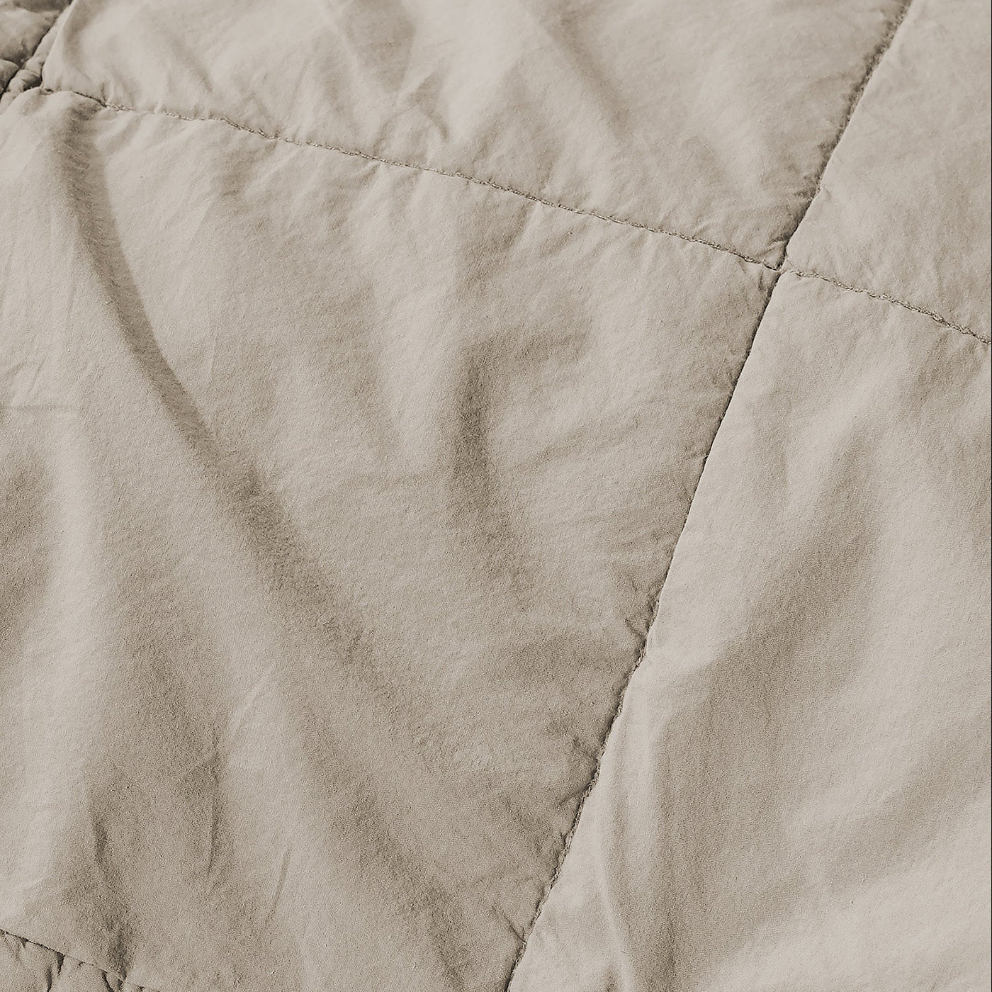 Close-up of Society Limonta Nite quilt diamond stitching in warm taupe linen.