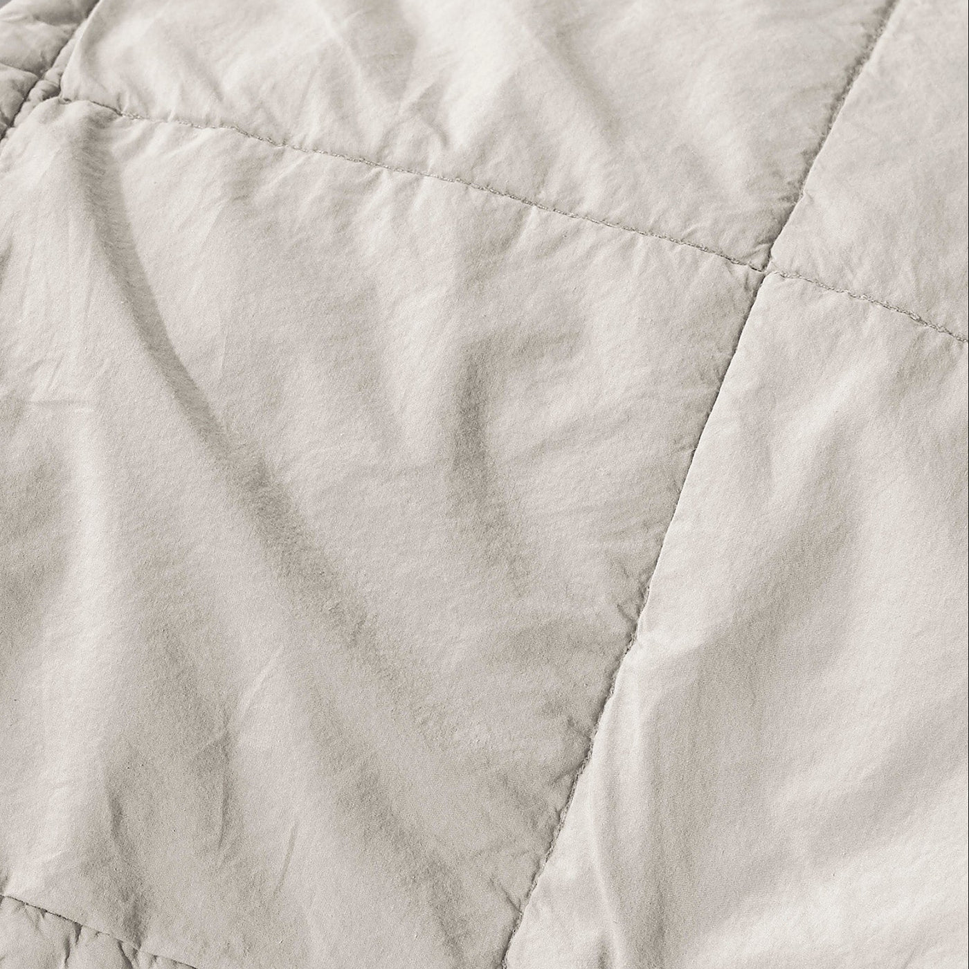 Close-up of Society Limonta Nite quilt showing diamond quilting on ivory linen.
