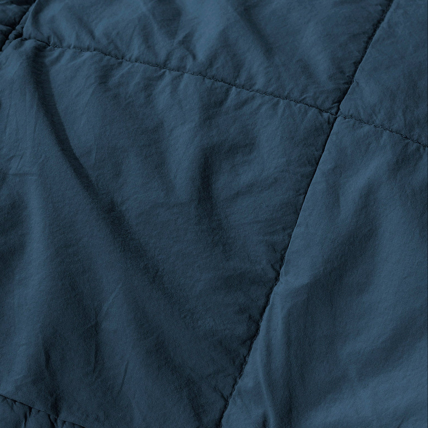 Close-up of Society Limonta Nite quilt showing navy diamond stitching on washed linen.