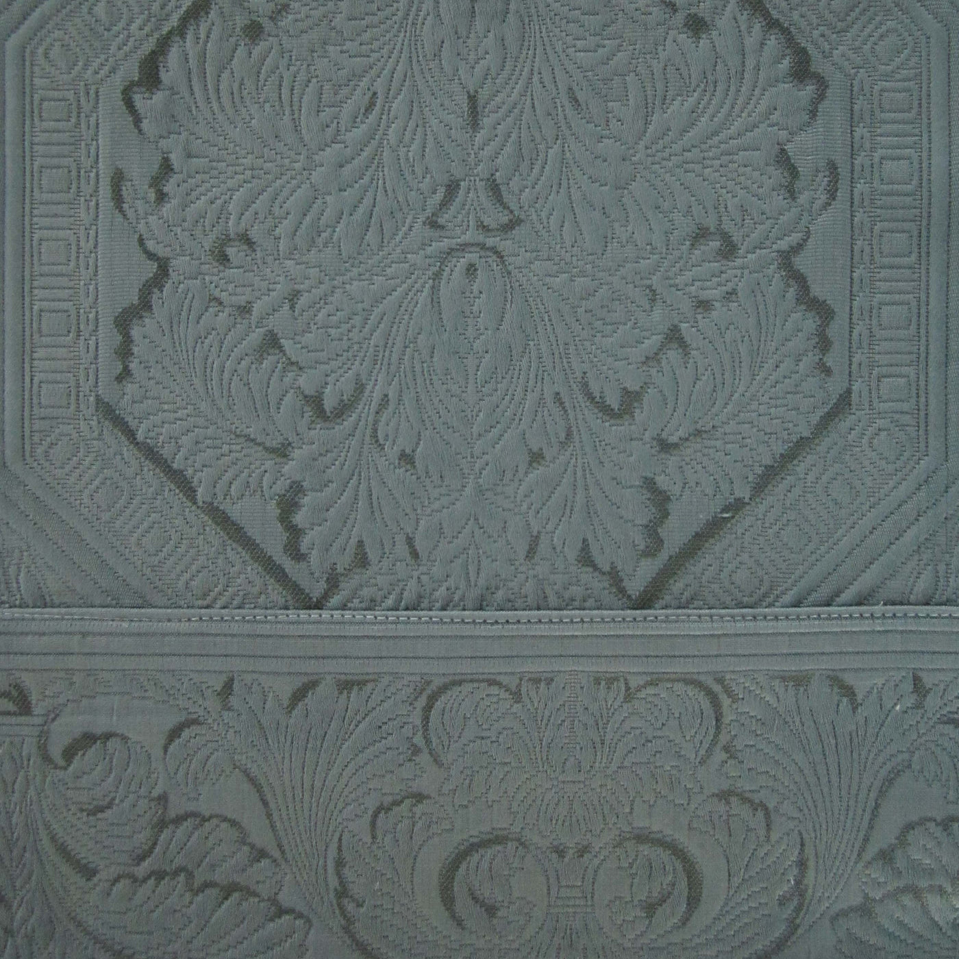 Close-up of Home Treasures Olympia slate blue damask jacquard fabric texture.