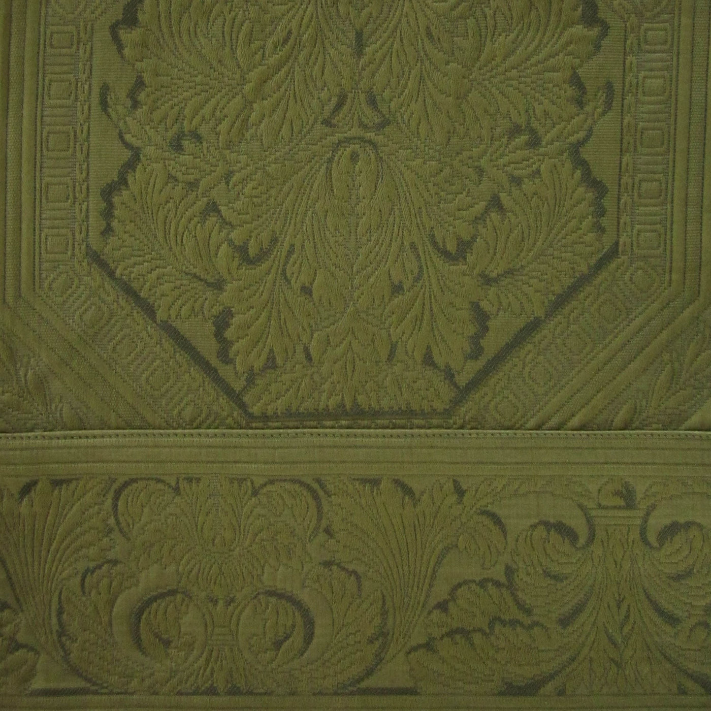 Close-up of olive green jacquard weave with ornate acanthus leaf medallion pattern.