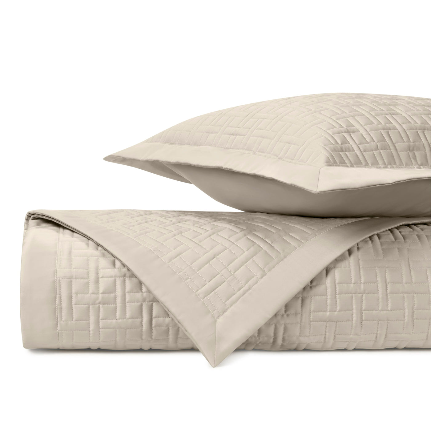 Close-up of ivory quilted basketweave stitching on Home Treasures Parquet coverlet and sham.