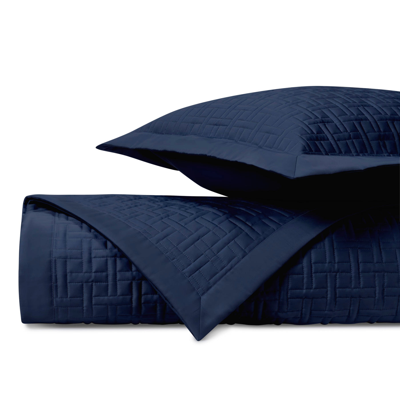 Close-up of Parquet quilted coverlet in navy with basket-weave stitching detail.