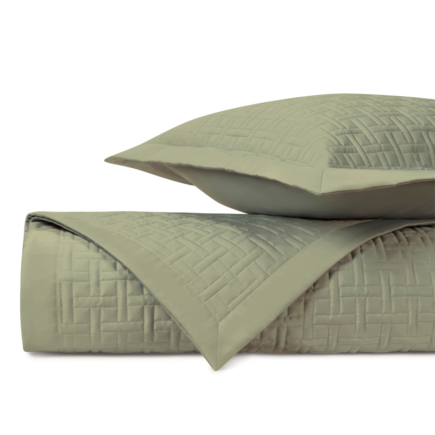 Close-up of sage green quilted coverlet and sham showing basket-weave stitch pattern.