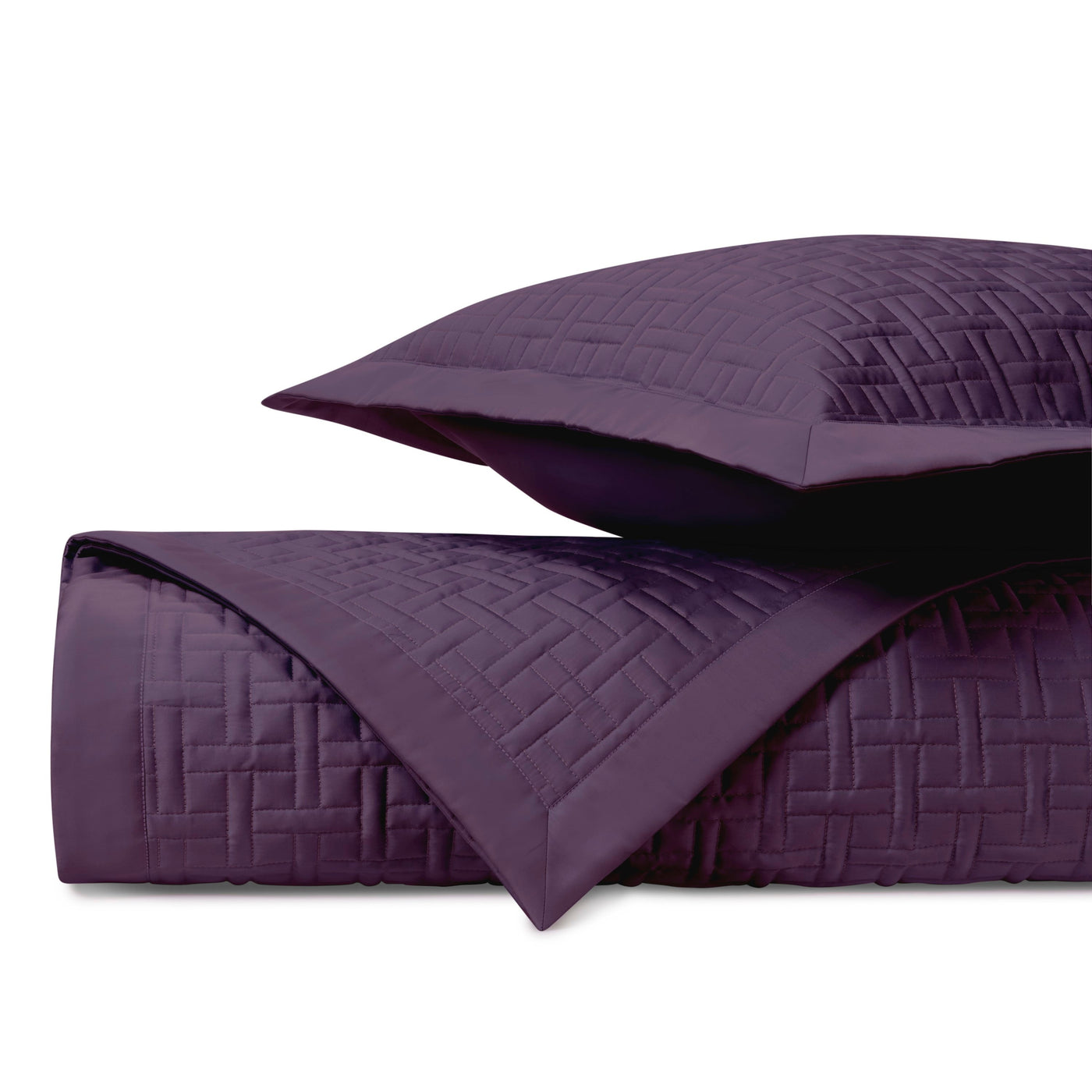 Close-up of Home Treasures Parquet quilted coverlet in deep plum with basket-weave stitching.