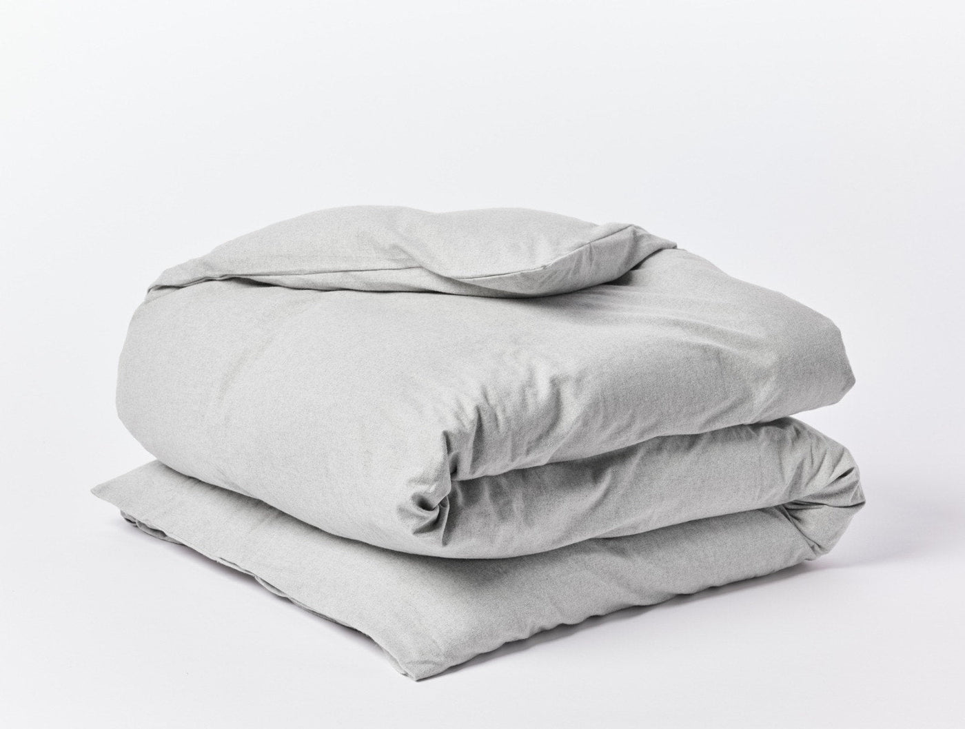 Close-up of folded Coyuchi Cloud Brushed Flannel duvet cover in heathered grey.