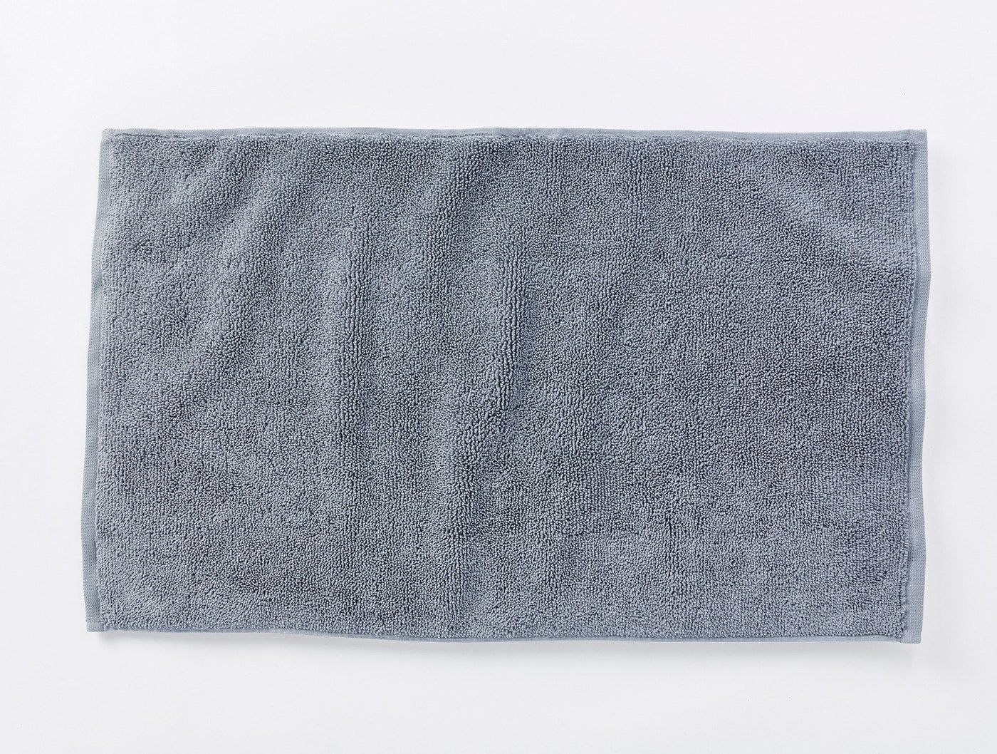 Coyuchi Cloud Loom bath rug in slate, flat lay showing plush terry texture.