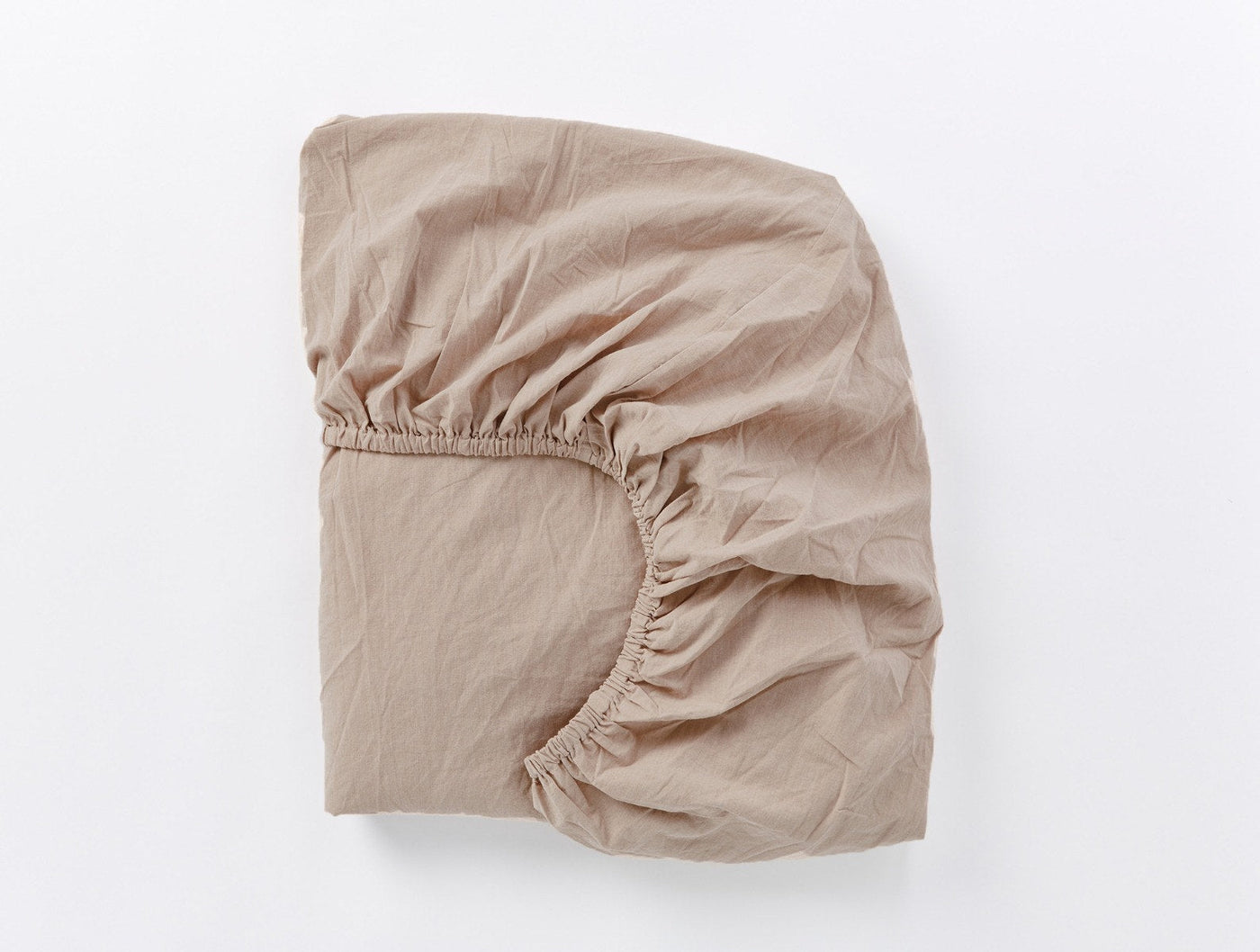 Fitted sheet corner detail showing elastic and relaxed crinkled percale texture in dune.