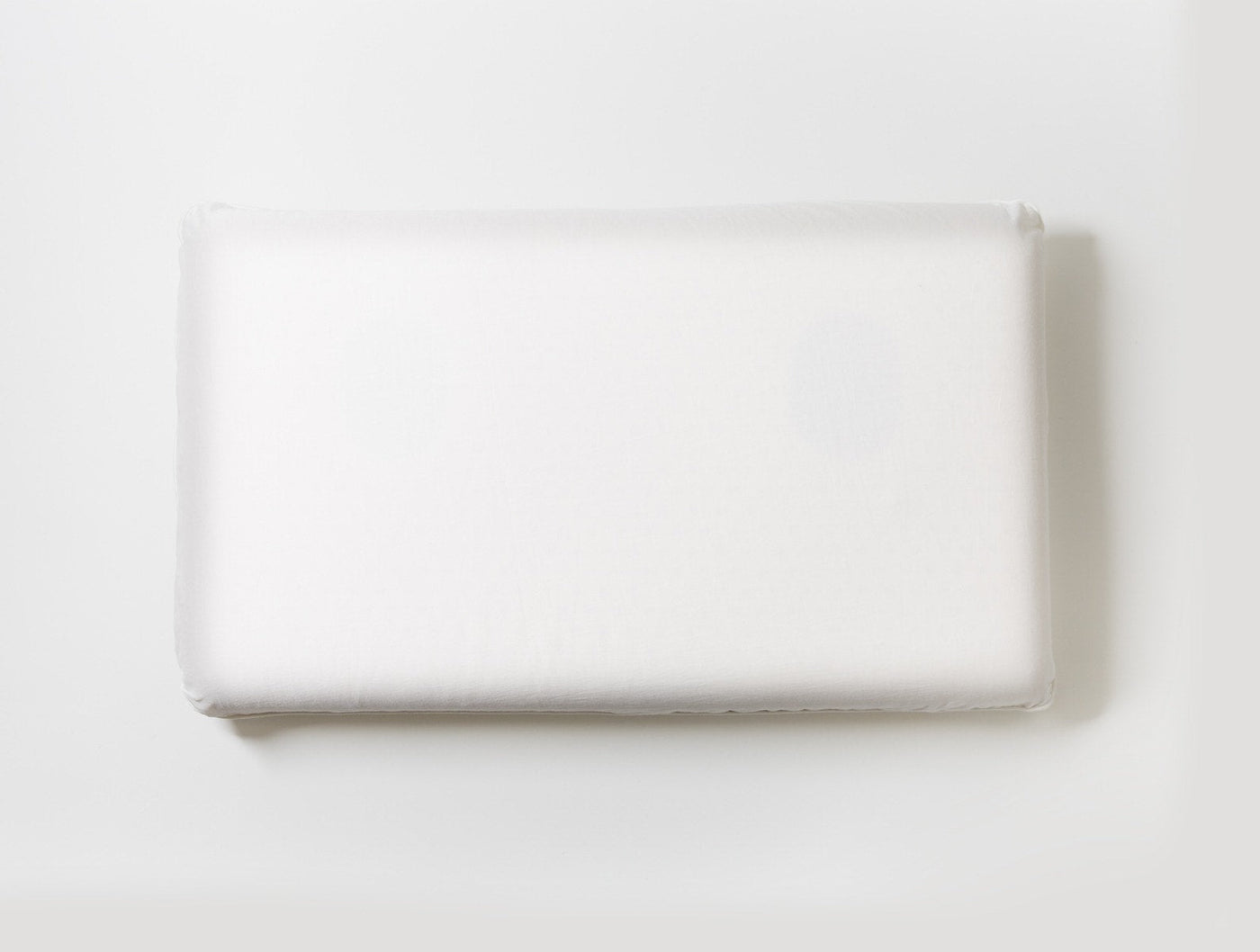 Coyuchi Turiya Latex pillow in white, viewed from above against white background.