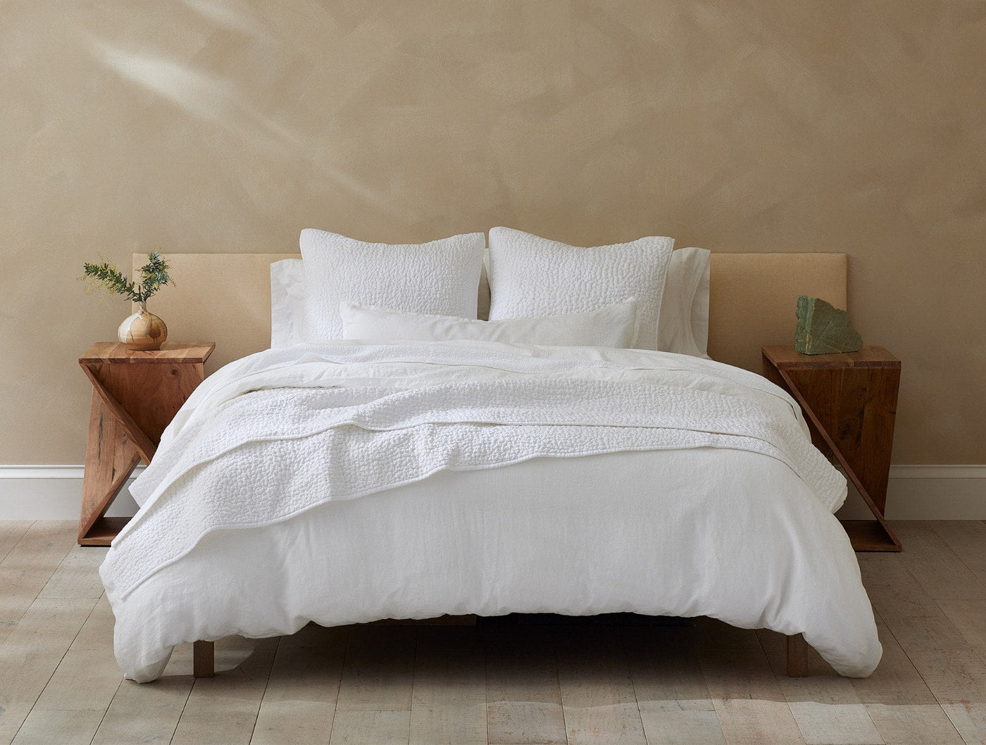 Coyuchi Relaxed Linen bedding styled on bed in white, with textured duvet and matching shams.