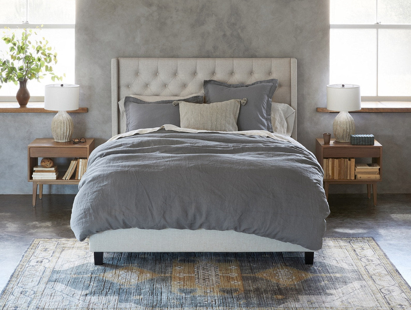 Coyuchi Relaxed Linen duvet cover in slate grey, styled on a made bed in a minimal bedroom.