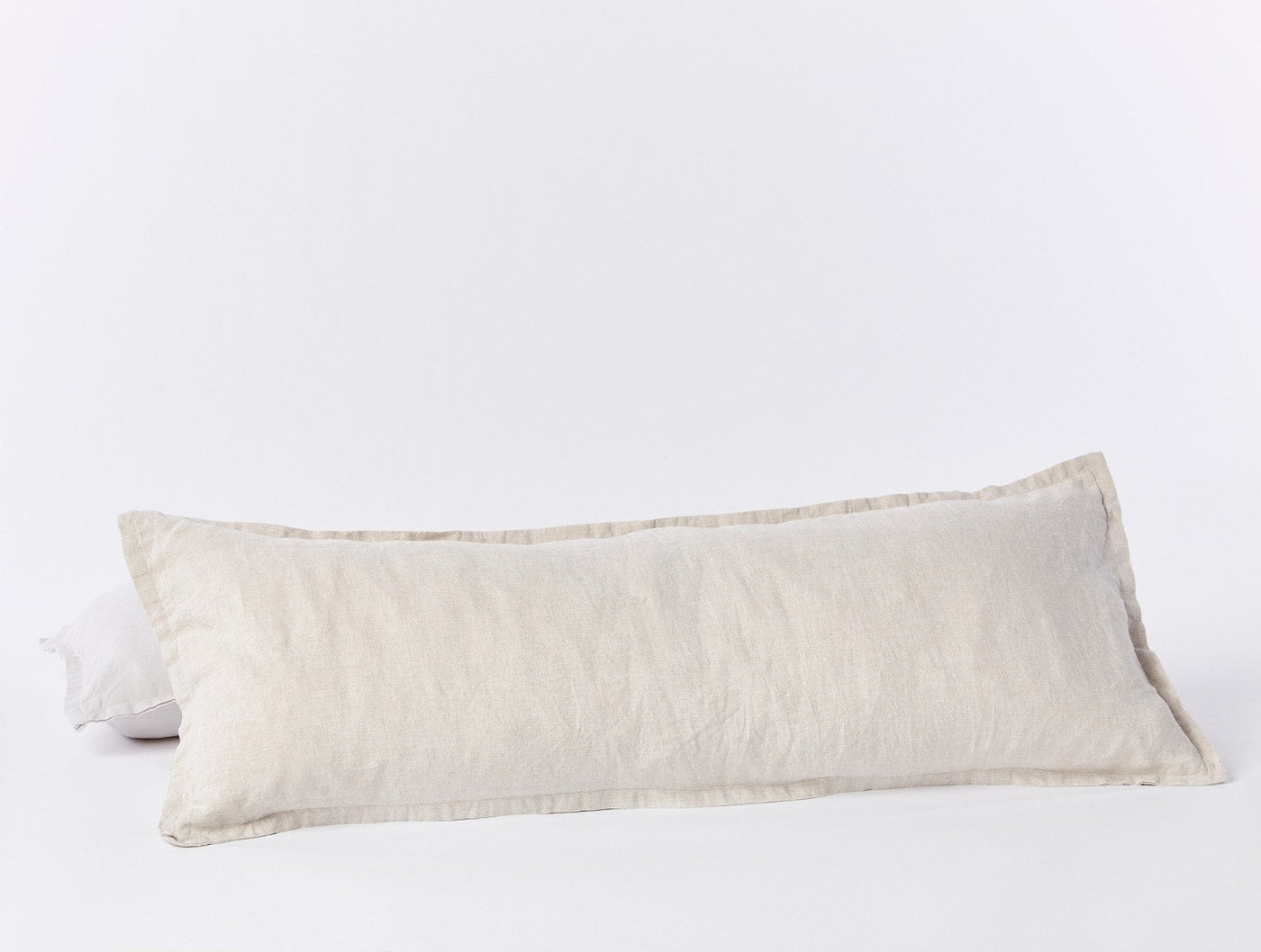 Coyuchi Relaxed Linen long lumbar pillow in natural, showing full side profile with flanged edge.
