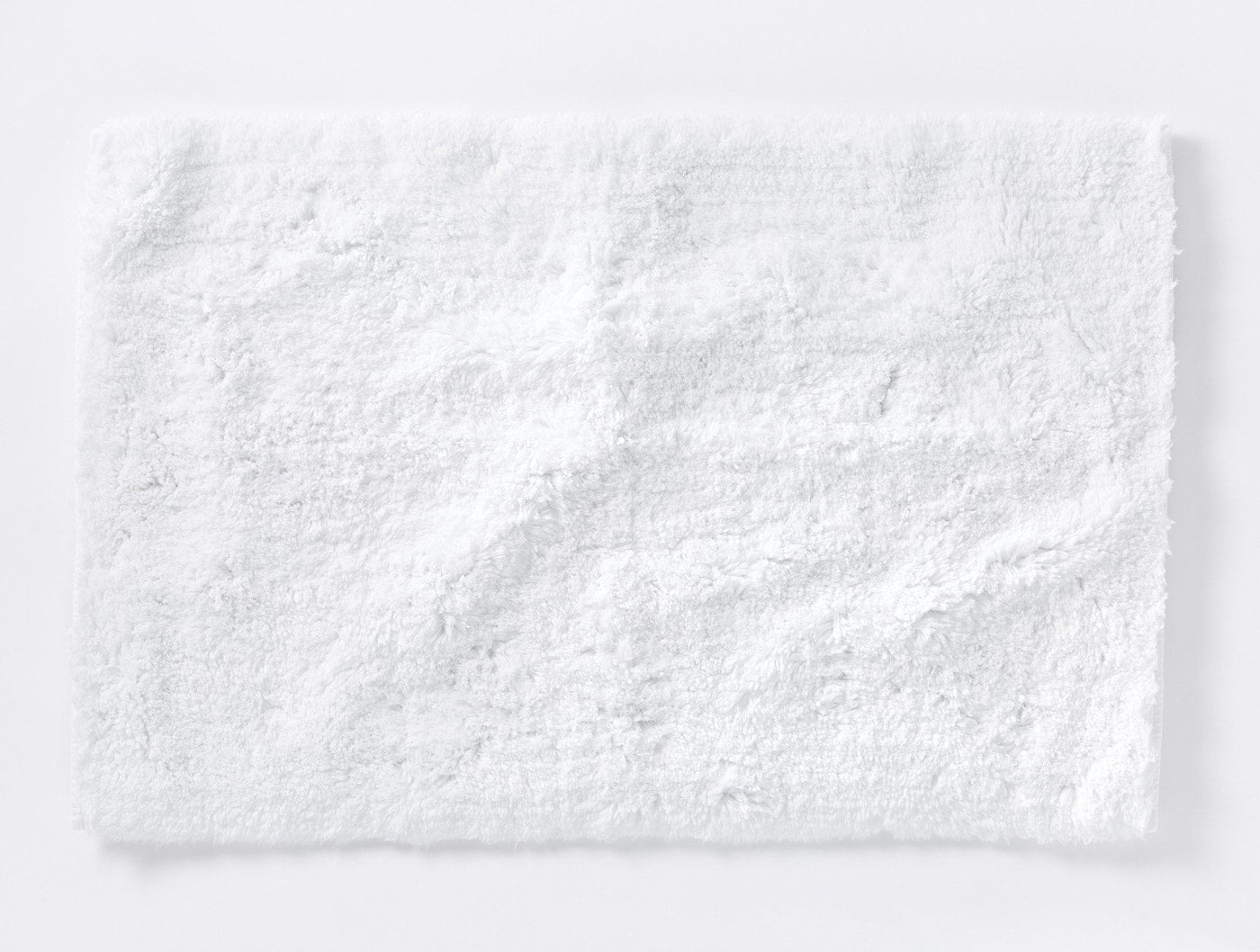 Coyuchi Shag bath rug in white, plush terry pile texture, laid flat.