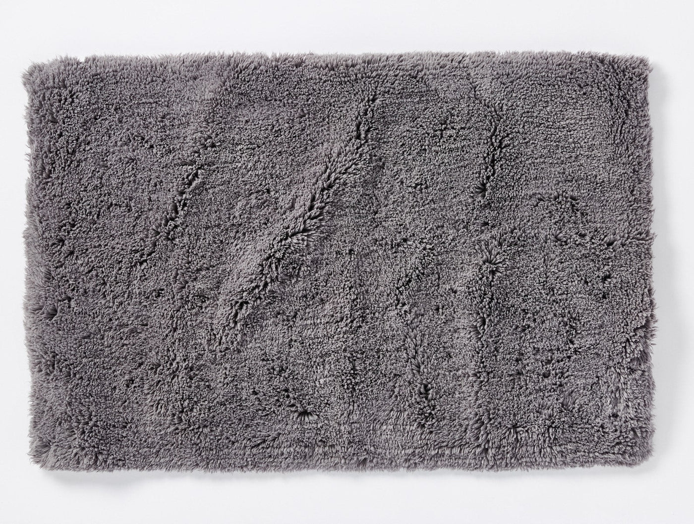 Coyuchi Shag bath rug in slate grey, close-up showing plush tufted texture.