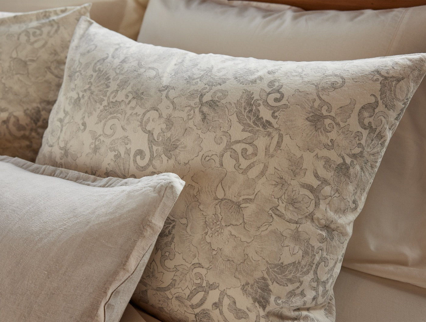 Close-up of Coyuchi Solana Print sham in champagne with gray floral damask pattern.