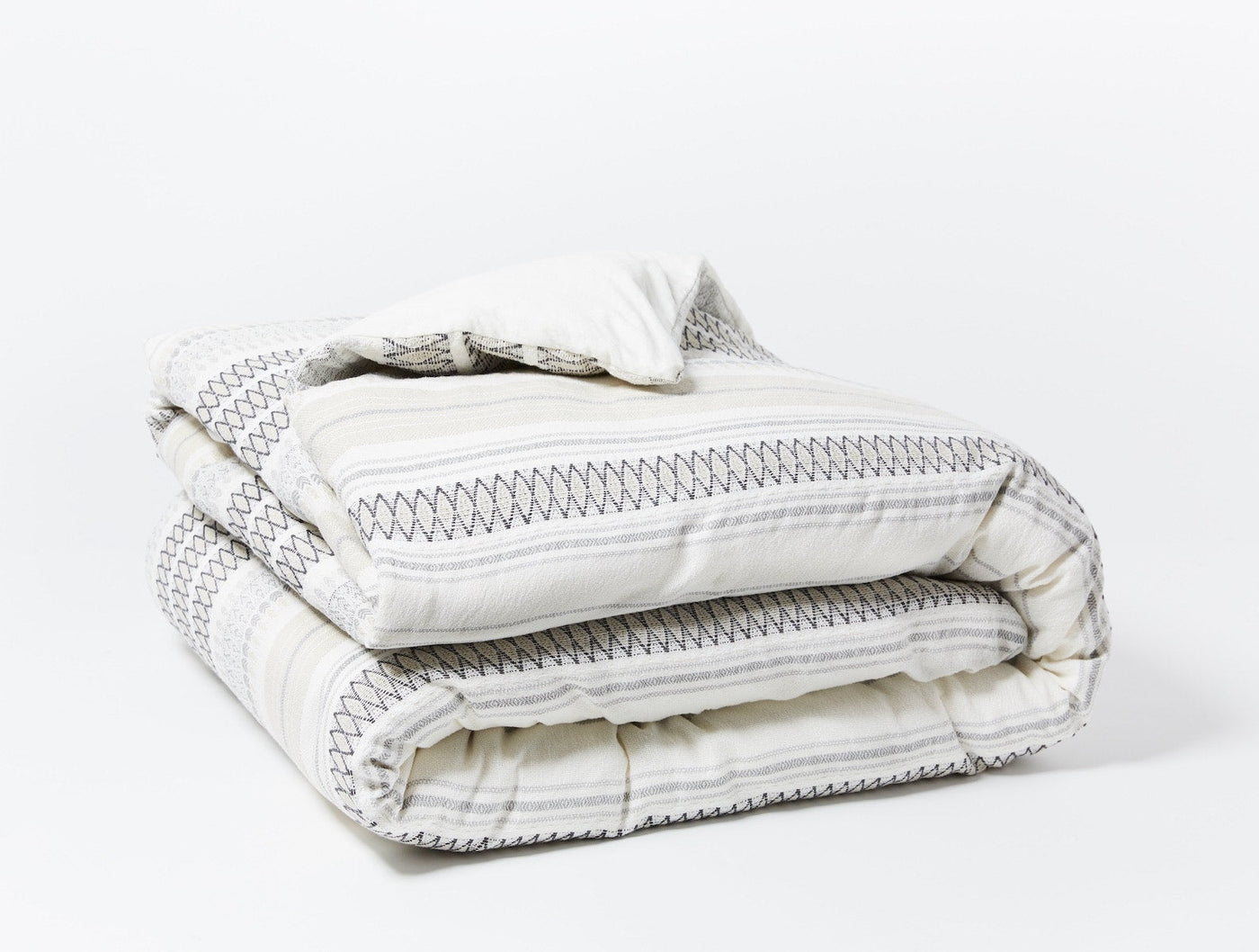 Coyuchi Lost Coast duvet cover, folded, ivory with charcoal stripe and stitch pattern.
