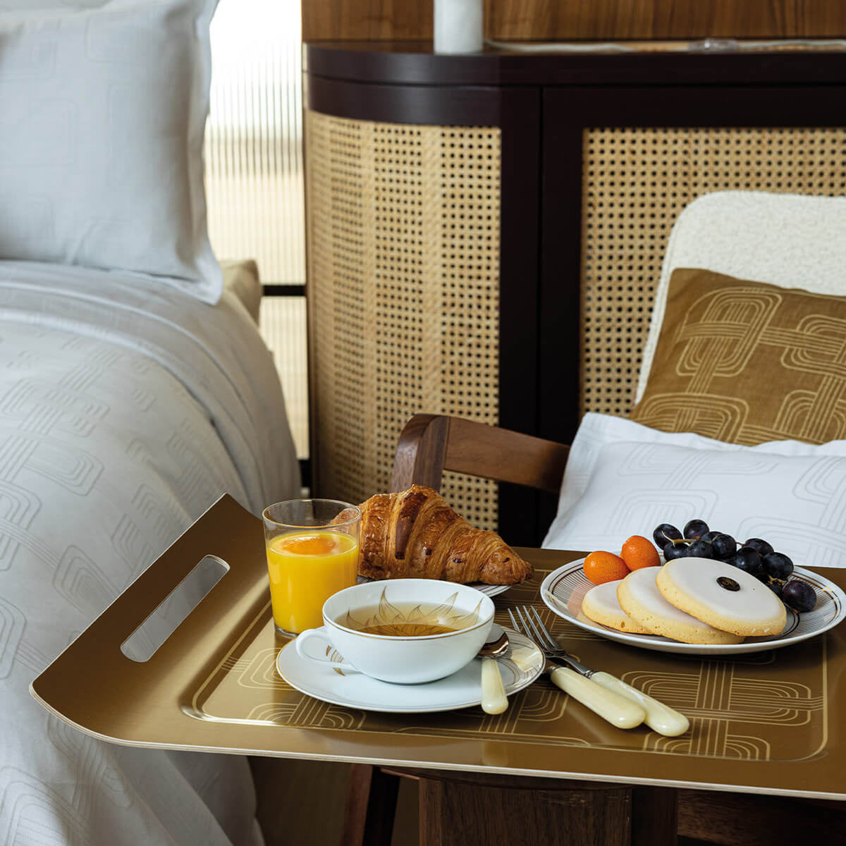 Le Jacquard Français Hôtel Particulier tray in Brown styled with breakfast items on a bedside chair.
