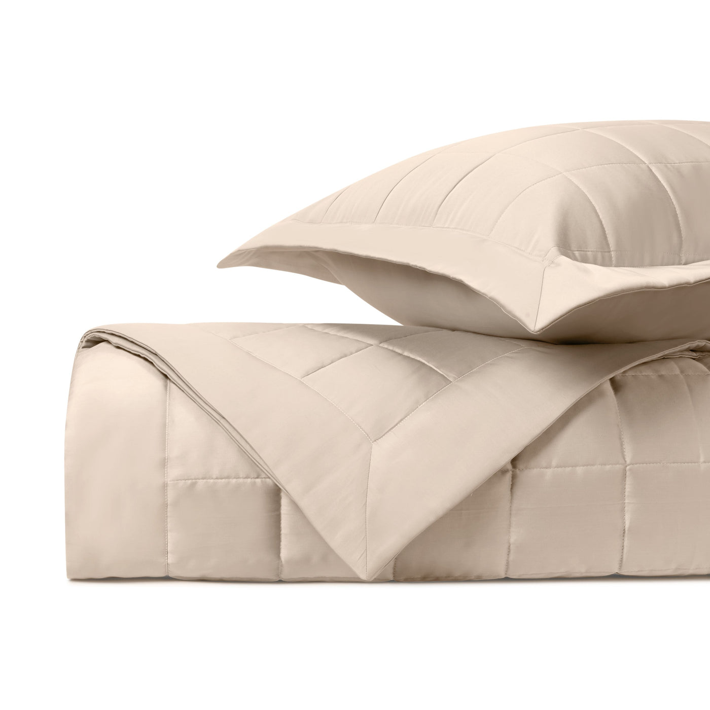 Close-up of Home Treasures Plateau quilted texture in ivory, folded with matching sham.