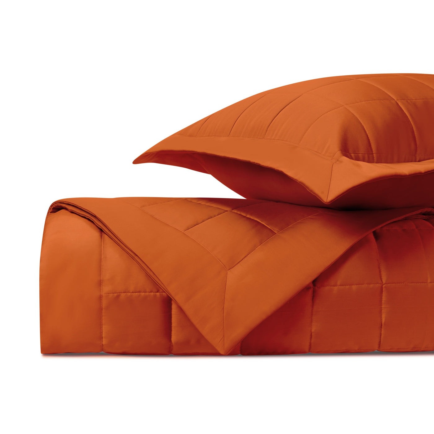 Close-up of Home Treasures Plateau quilted comforter and sham in tangerine.