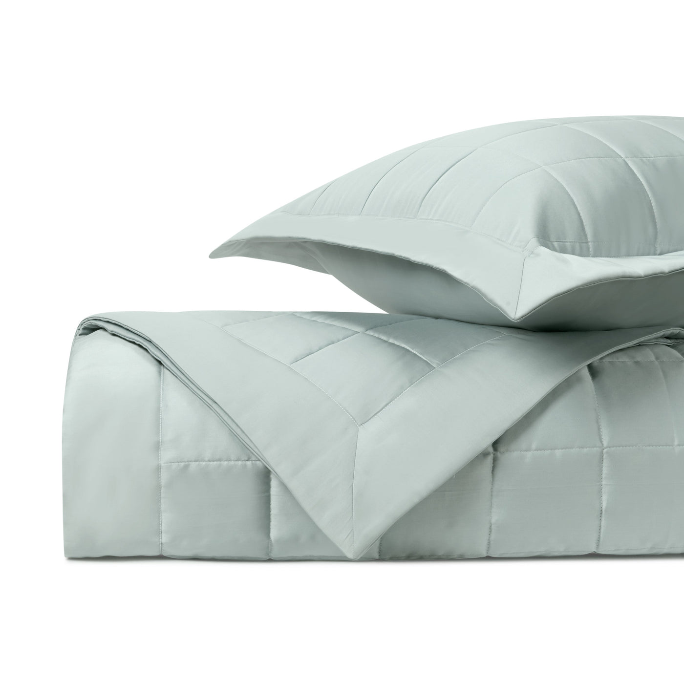 Close-up of Home Treasures Plateau quilted texture in mist blue, folded with matching sham.