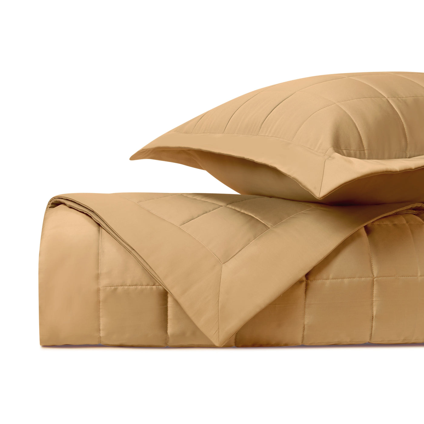 Close-up of Home Treasures Plateau quilted cotton in caramel with grid-stitched texture.